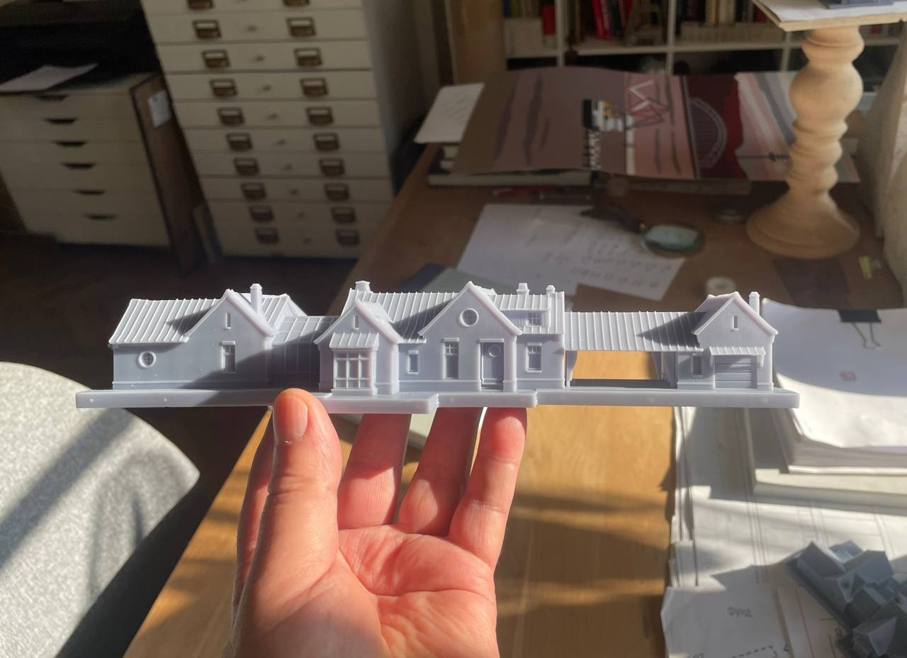 3d printed house is being hold by a person