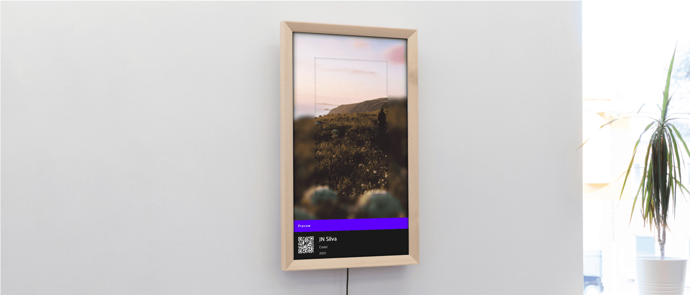 NFT display mounted on a wall, showcasing vibrant digital artwork in a sleek, minimalist frame.