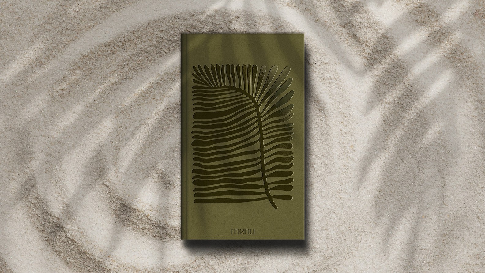 Menu Design placed on sand, seaside Kochili All-Day Experience