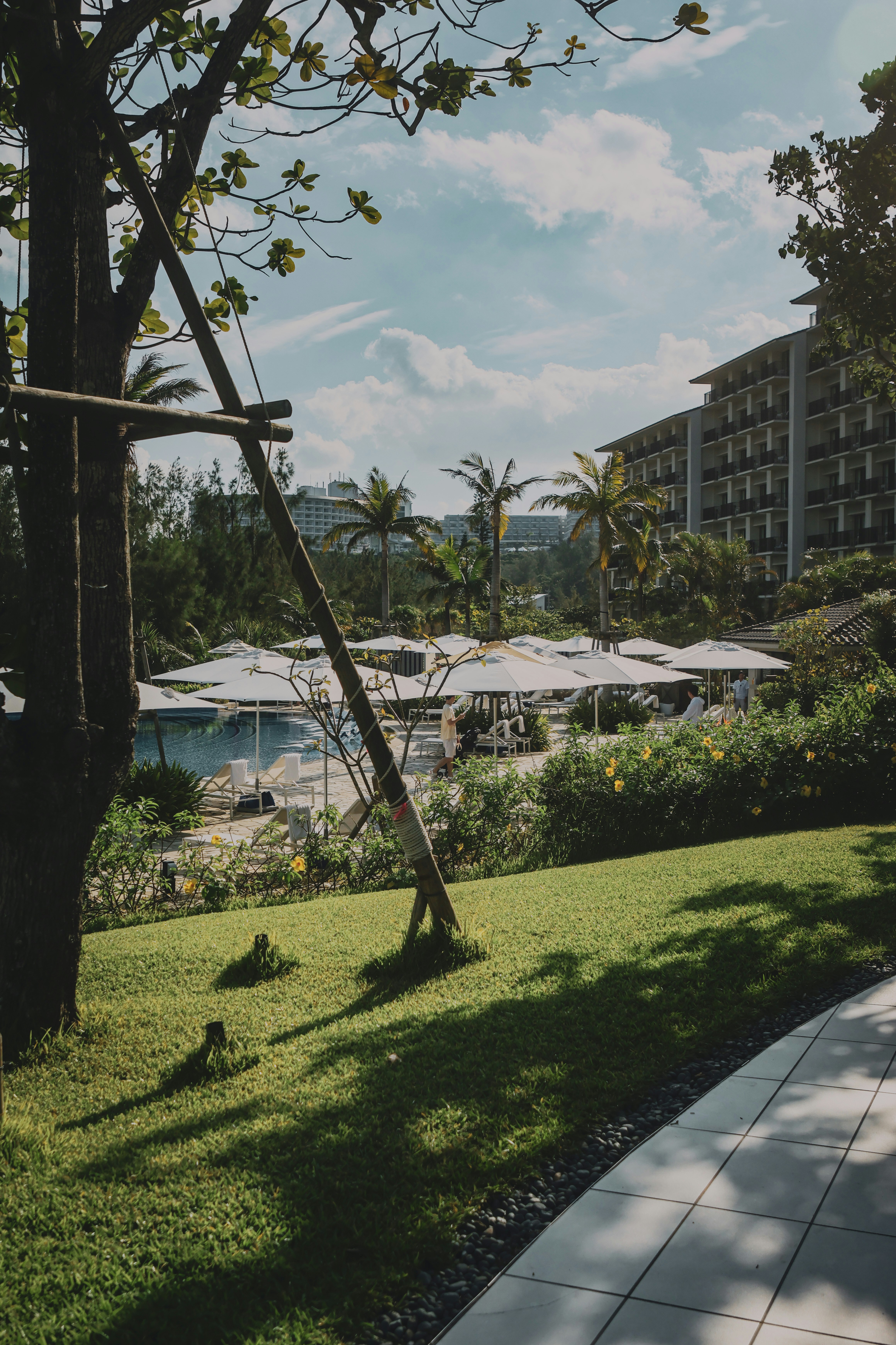 A walkway next to a lush green park
