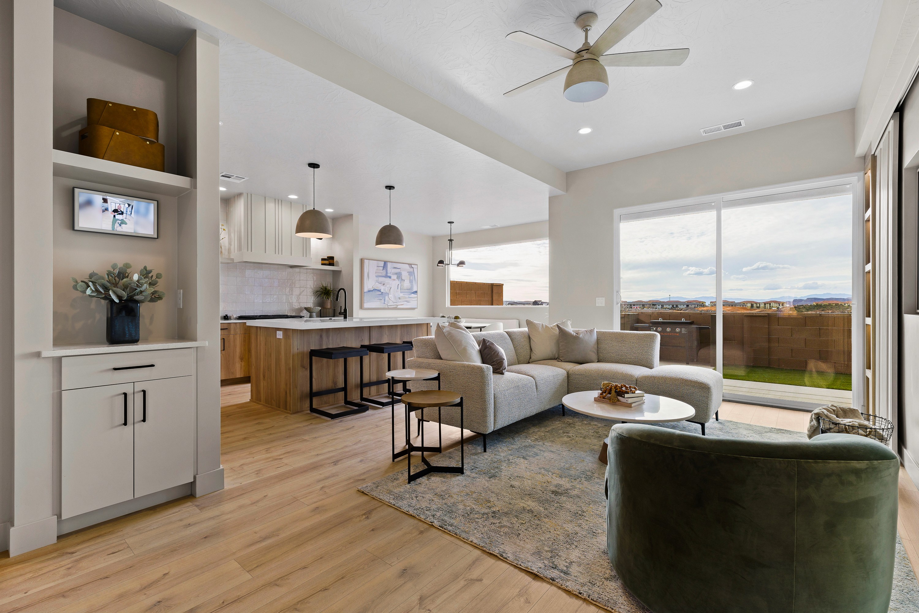 Living area in the BYSO House in Hurricane, Utah showing built-in drop center, kitchen, and seating space.
