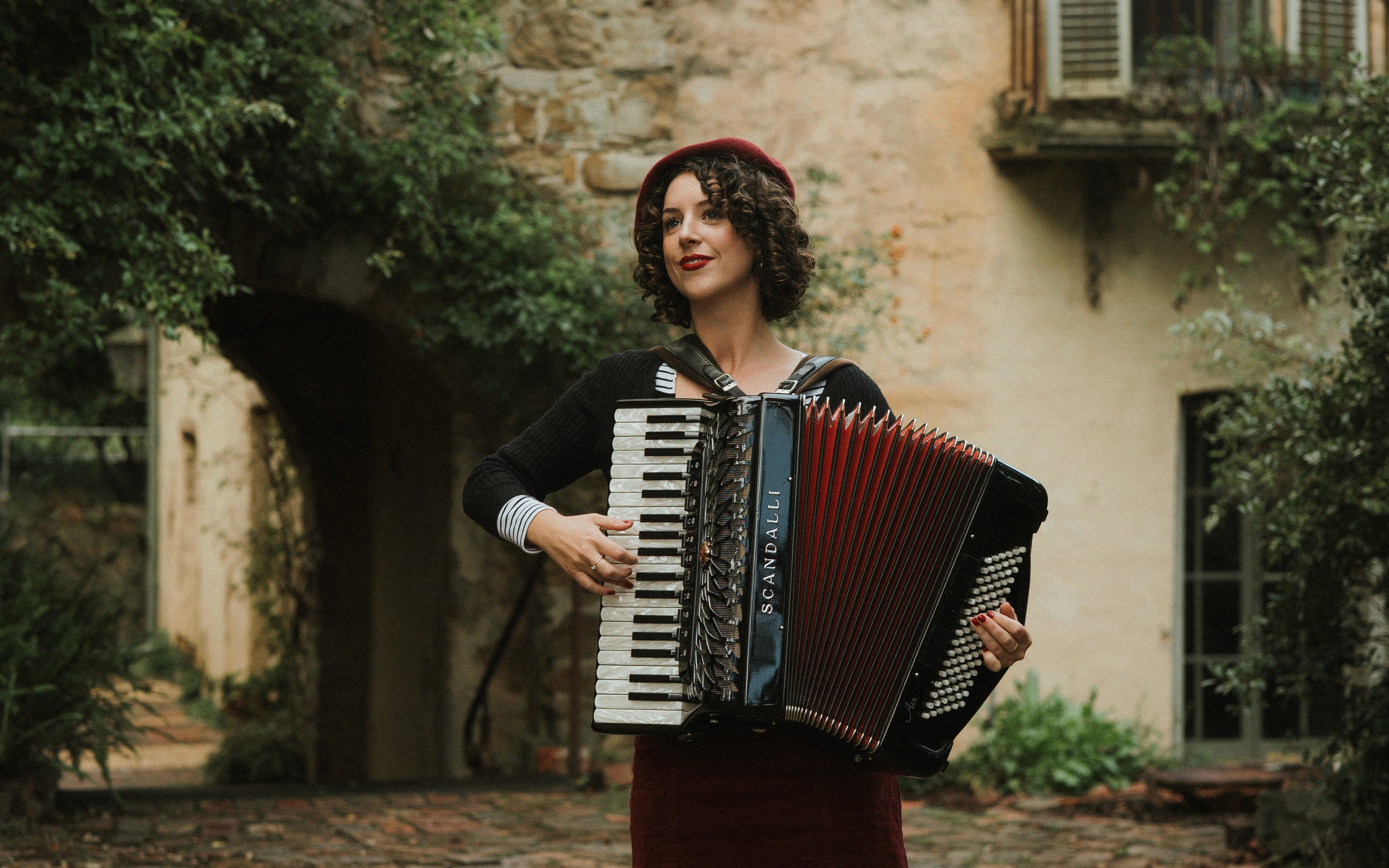 Lucy performing at an event on her red accordion