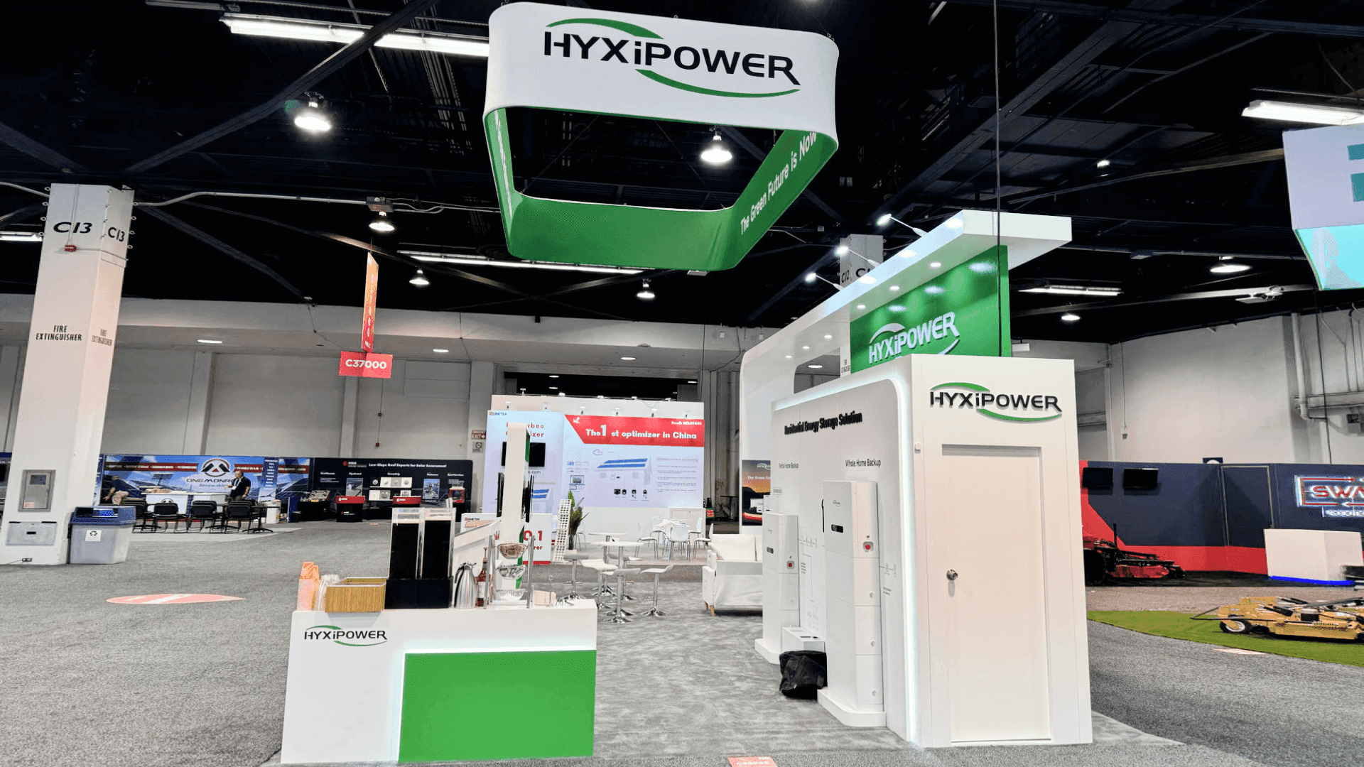 Wide view of HyxiPower 20x30 booth showing central demo counter and open visitor flow at RE+ 2024.