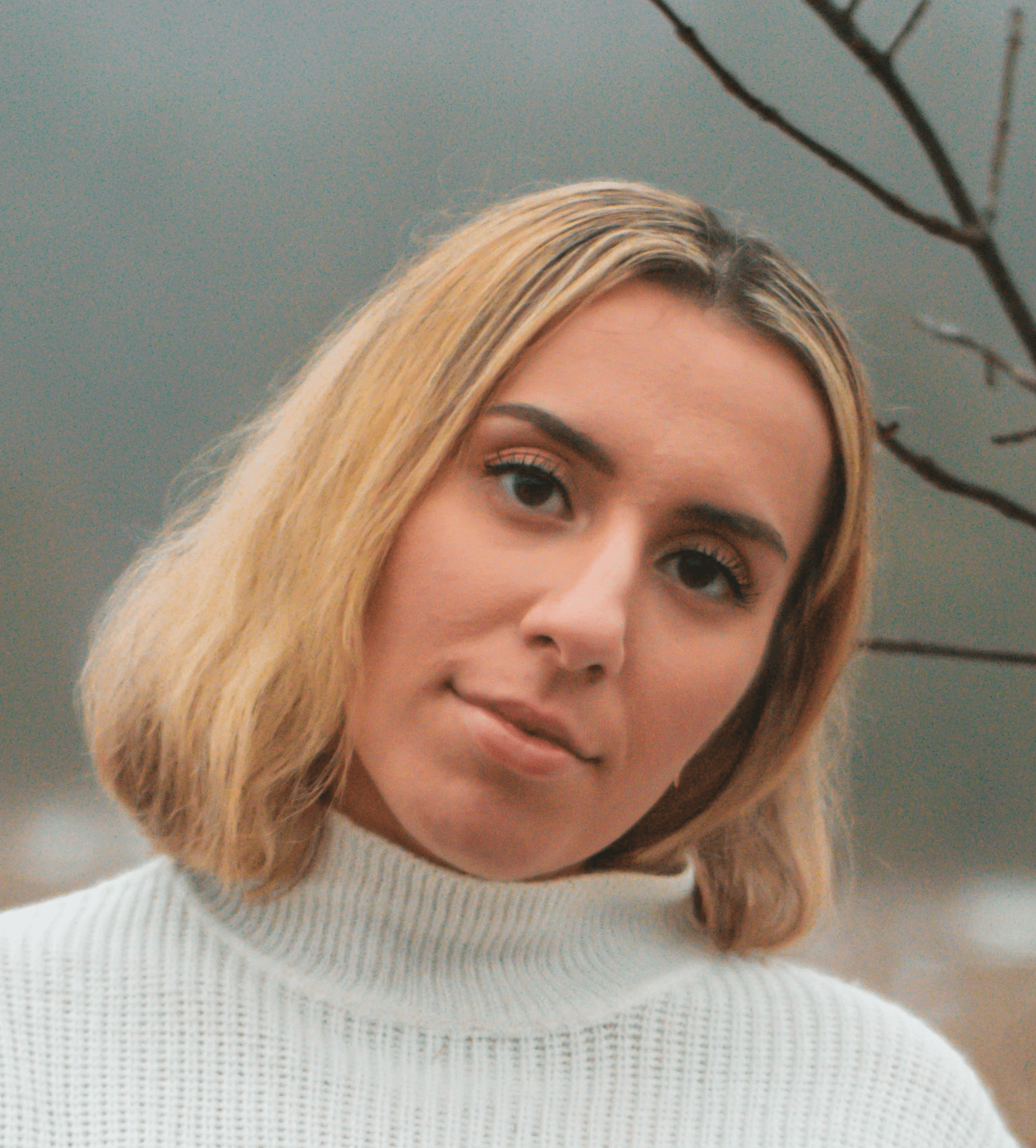 portrait photography of woman wearing white sweater and blue denim jeans