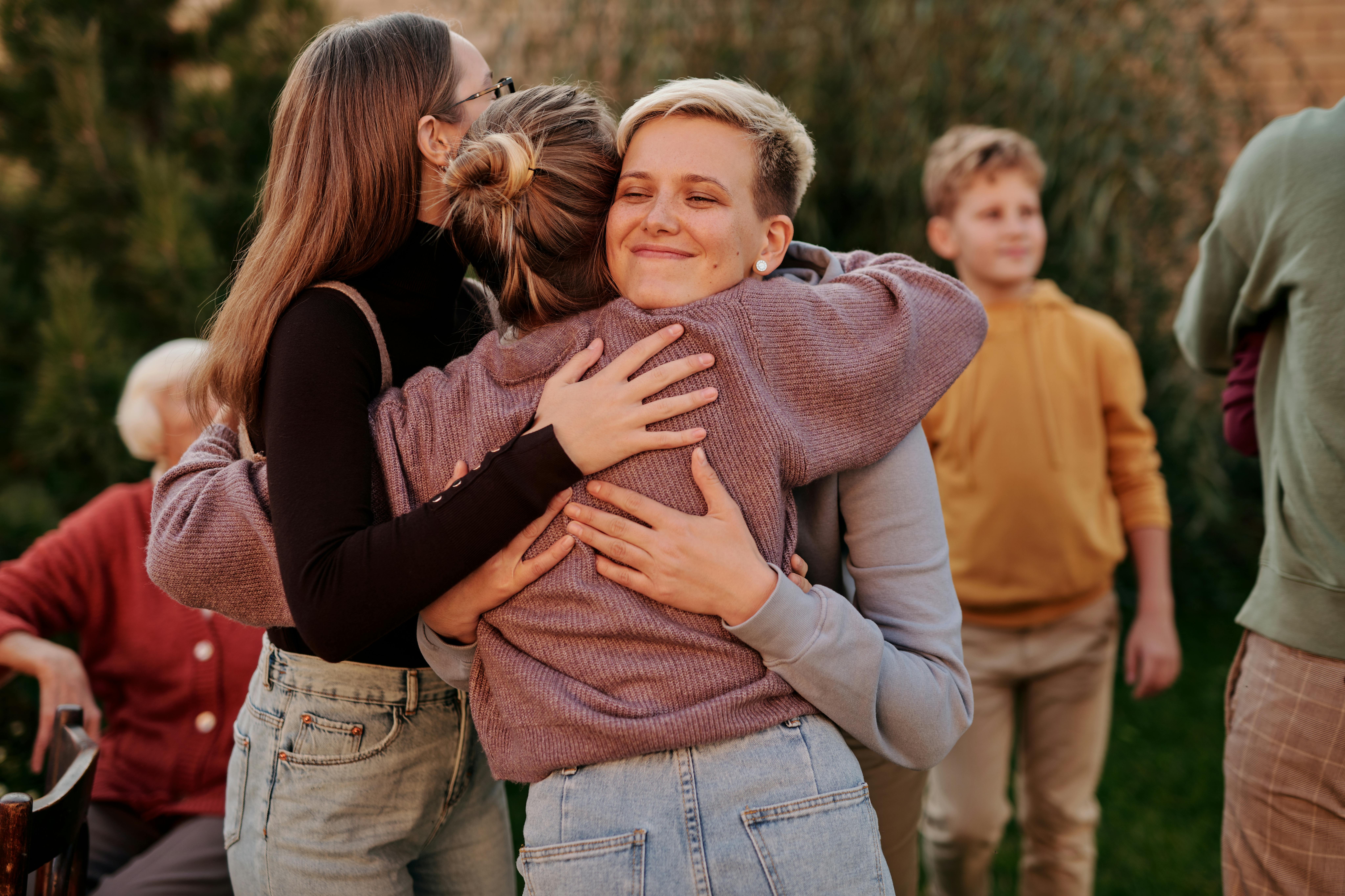 Three women hugging each other
