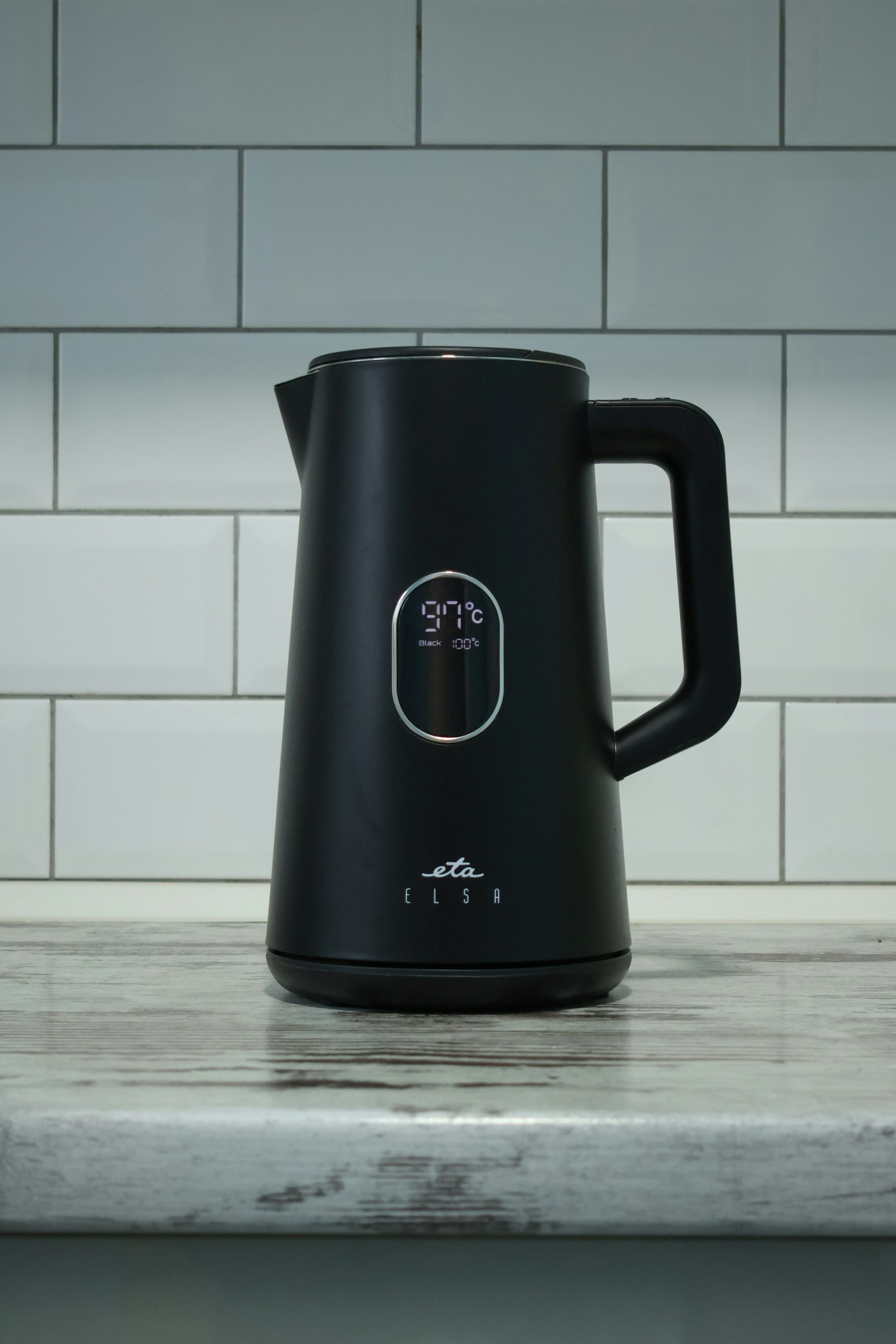 A black coffee pot sitting on top of a counter