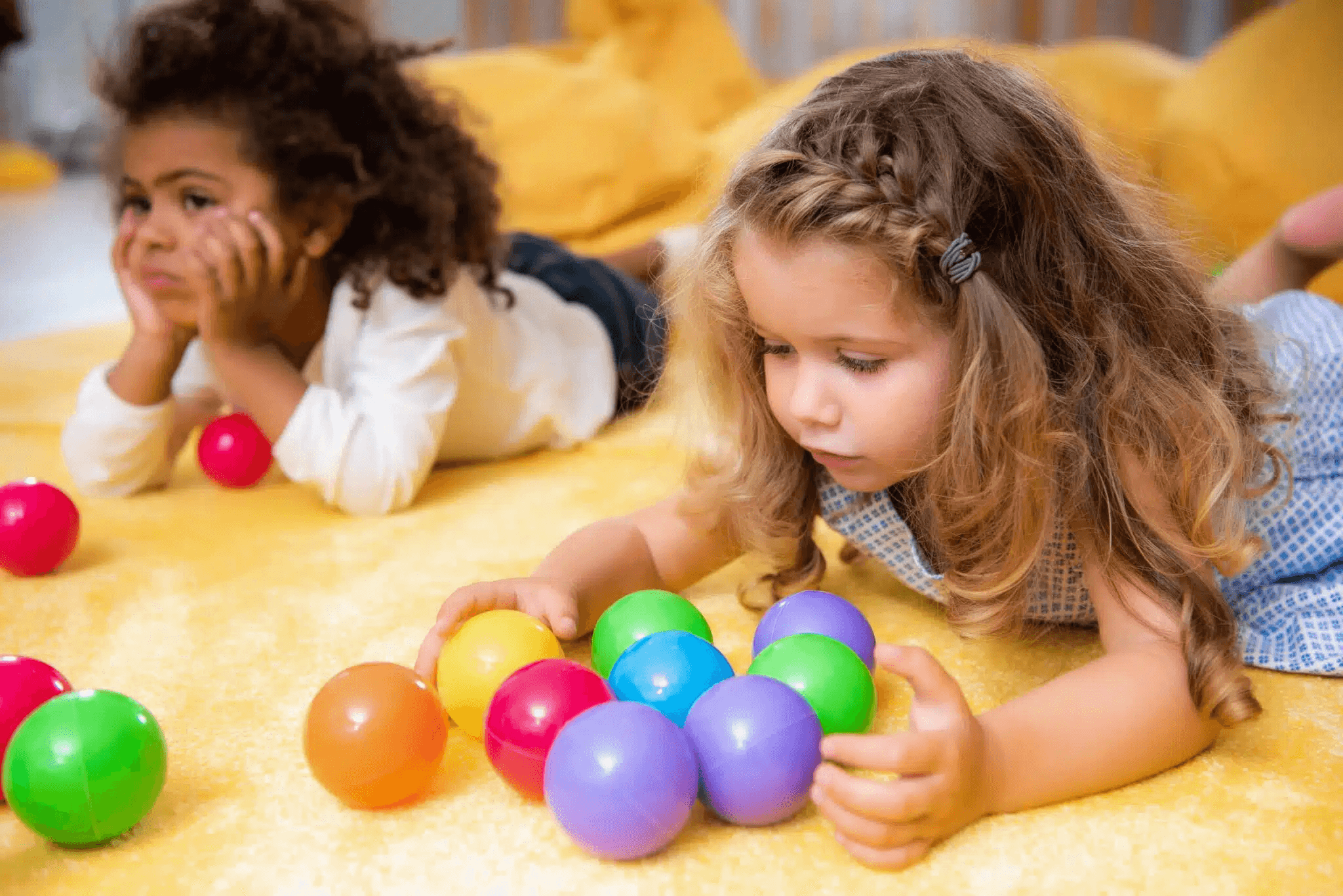 Children playing with coloured plastic balls