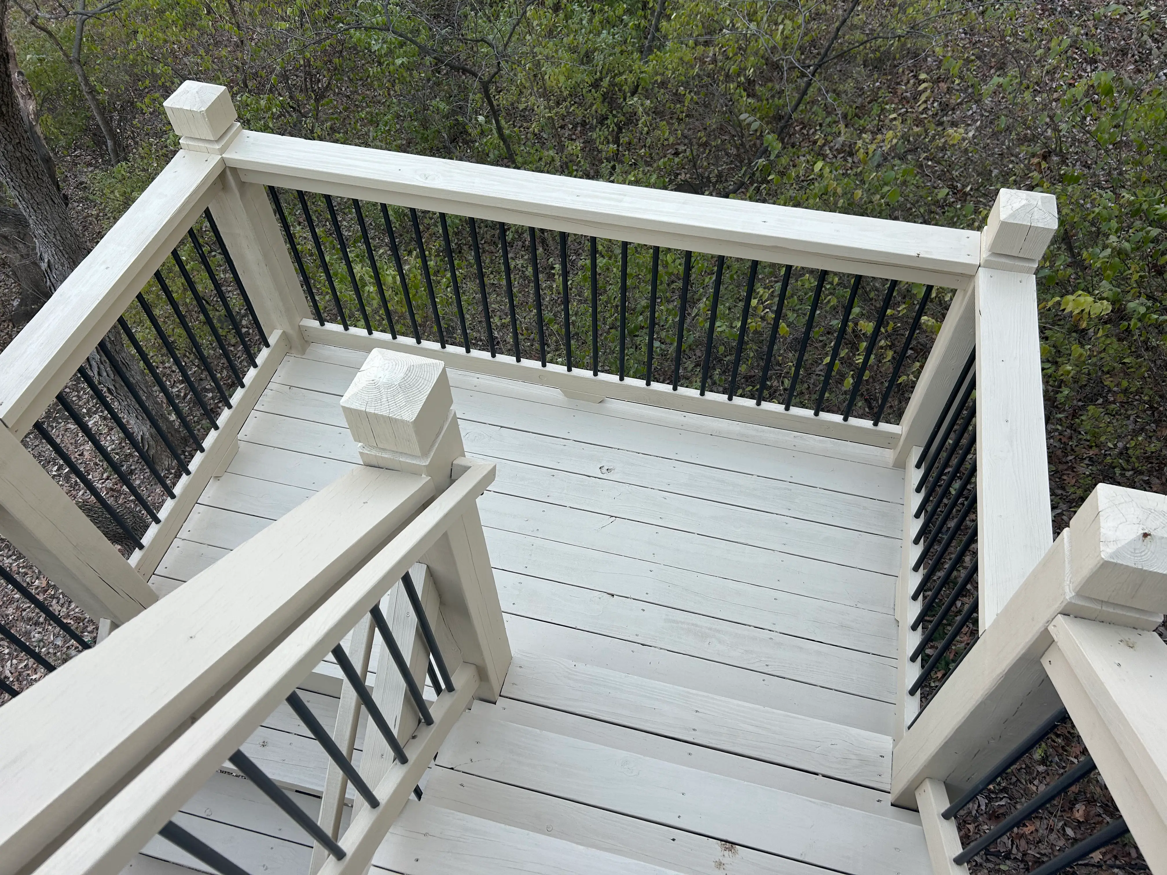 An image of a newly repair wood deck stairs and landing.