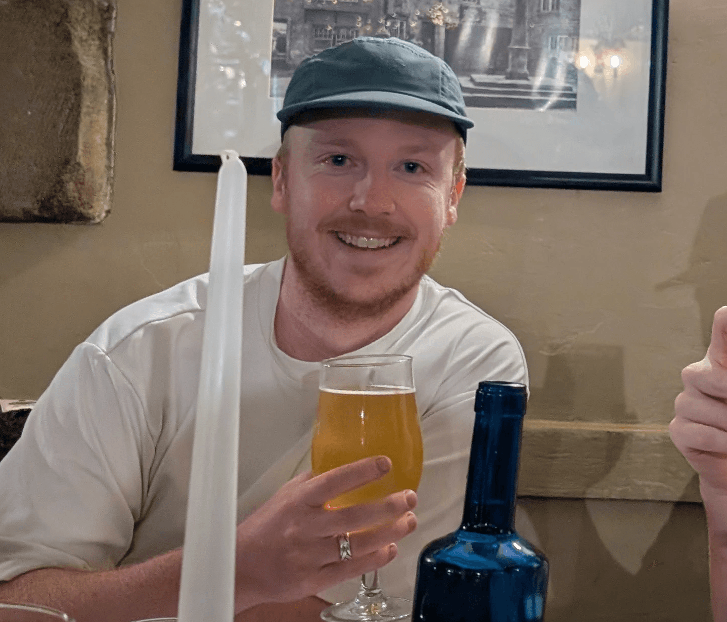 headshot of male drinking a pint of beer