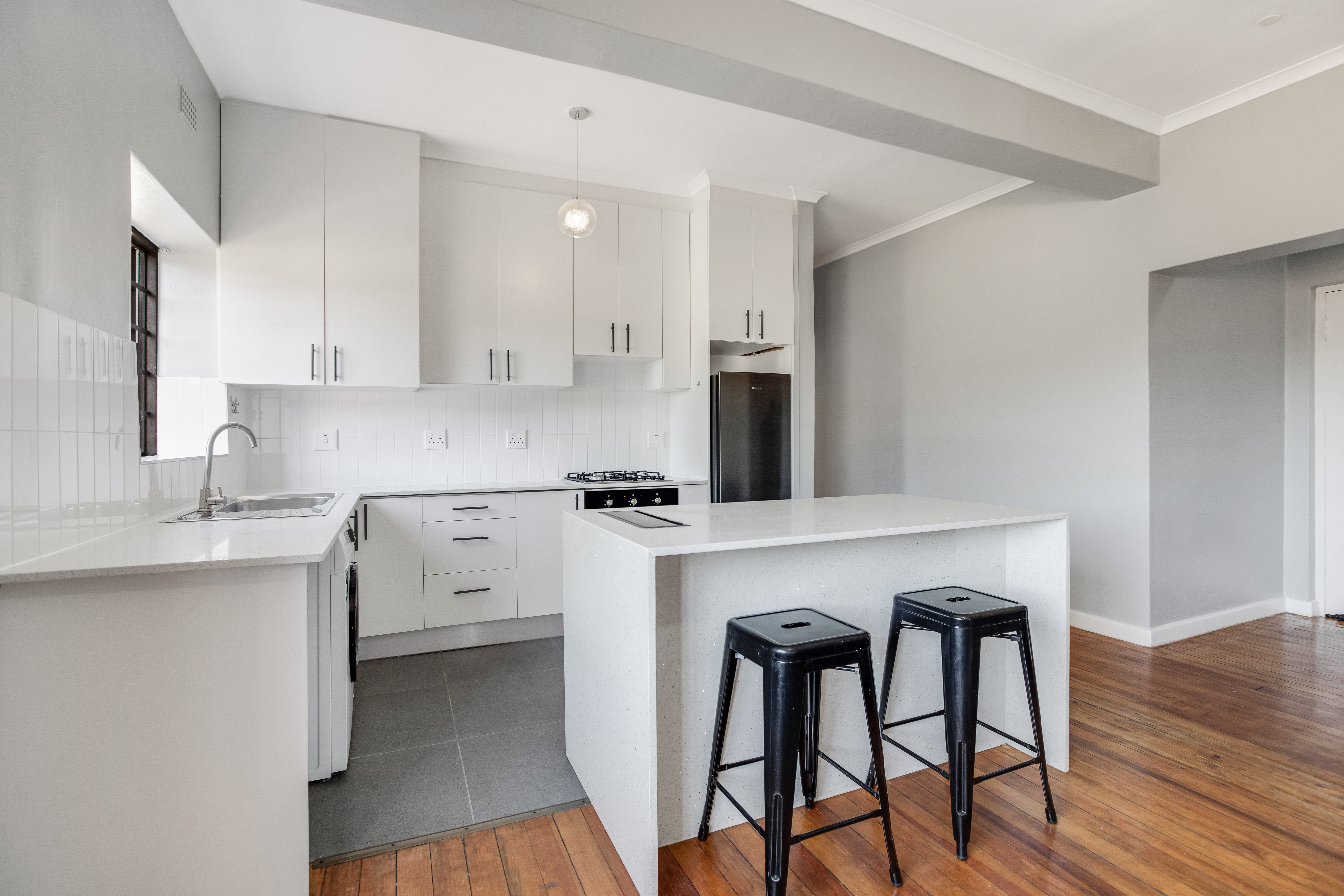 Modern fully furnished apartment kitchen with appliances included in Cape Town rental.