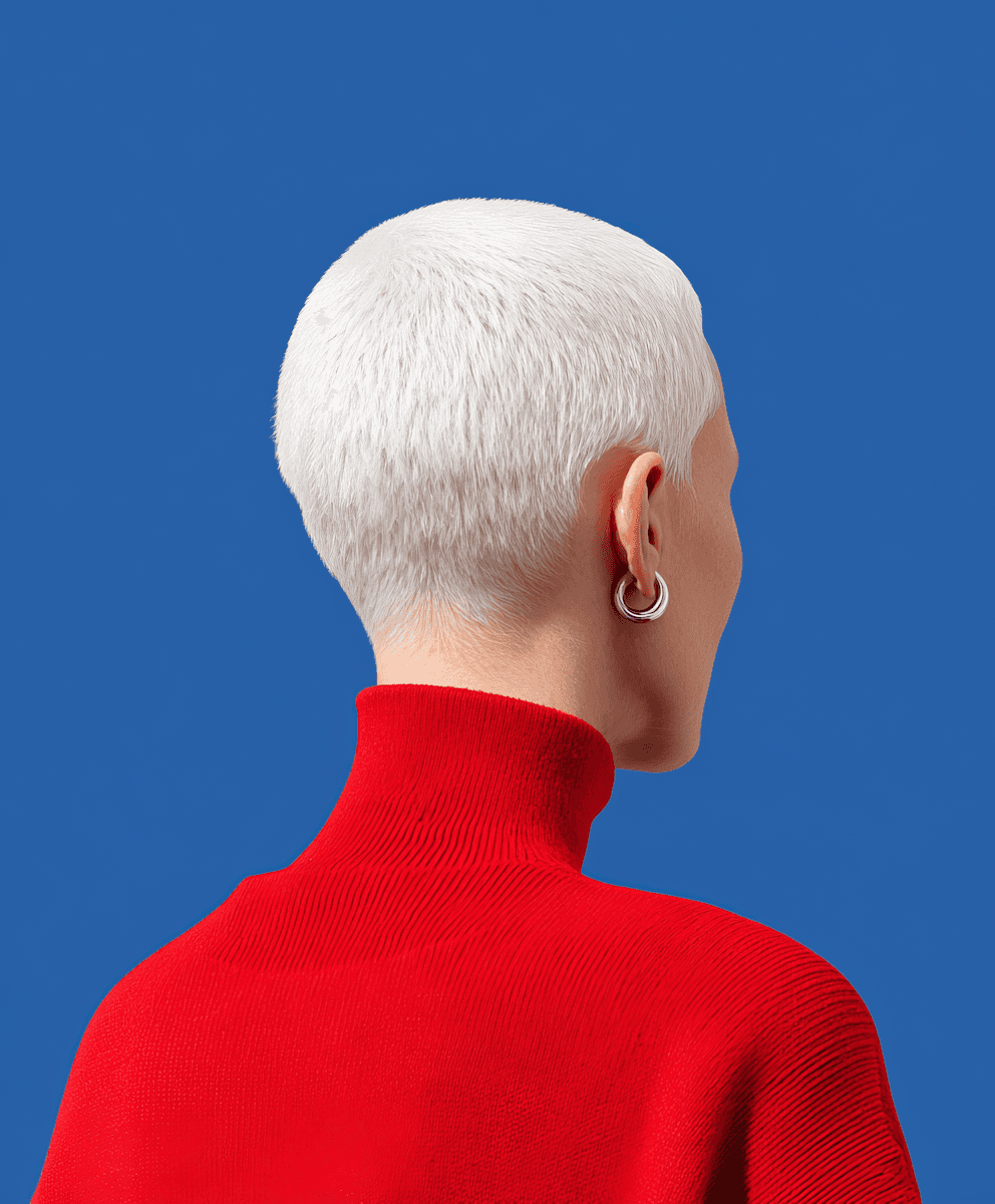 Back view of a person with a platinum buzz cut wearing a red turtleneck against a blue background.
