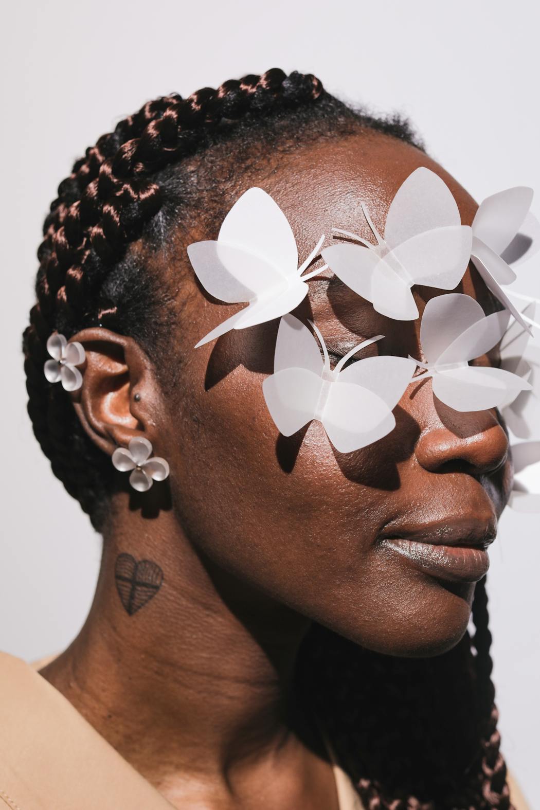 Woman portrait with paper butterflys on her eyes