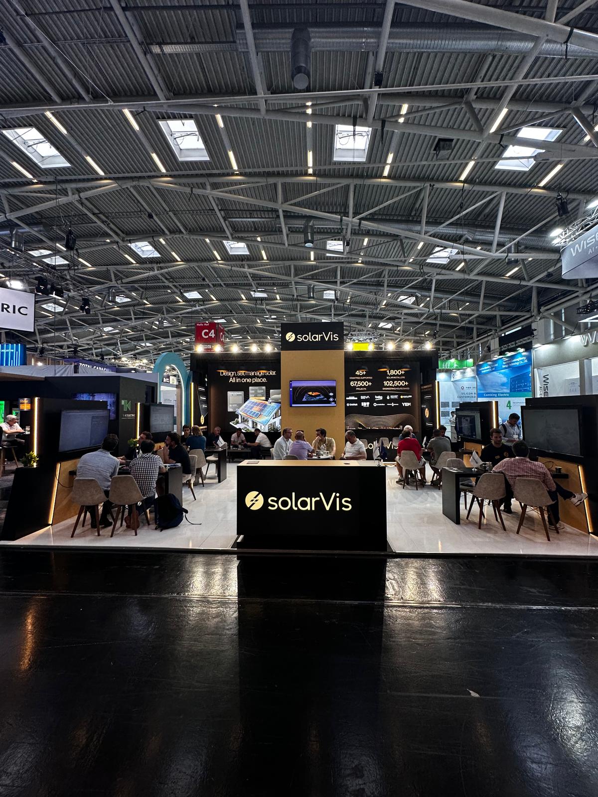 SolarVis exhibition stand at Intersolar 2026 Munich, featuring a strong black, gold, and yellow brand identity with illuminated graphics and bold vertical brand towers.