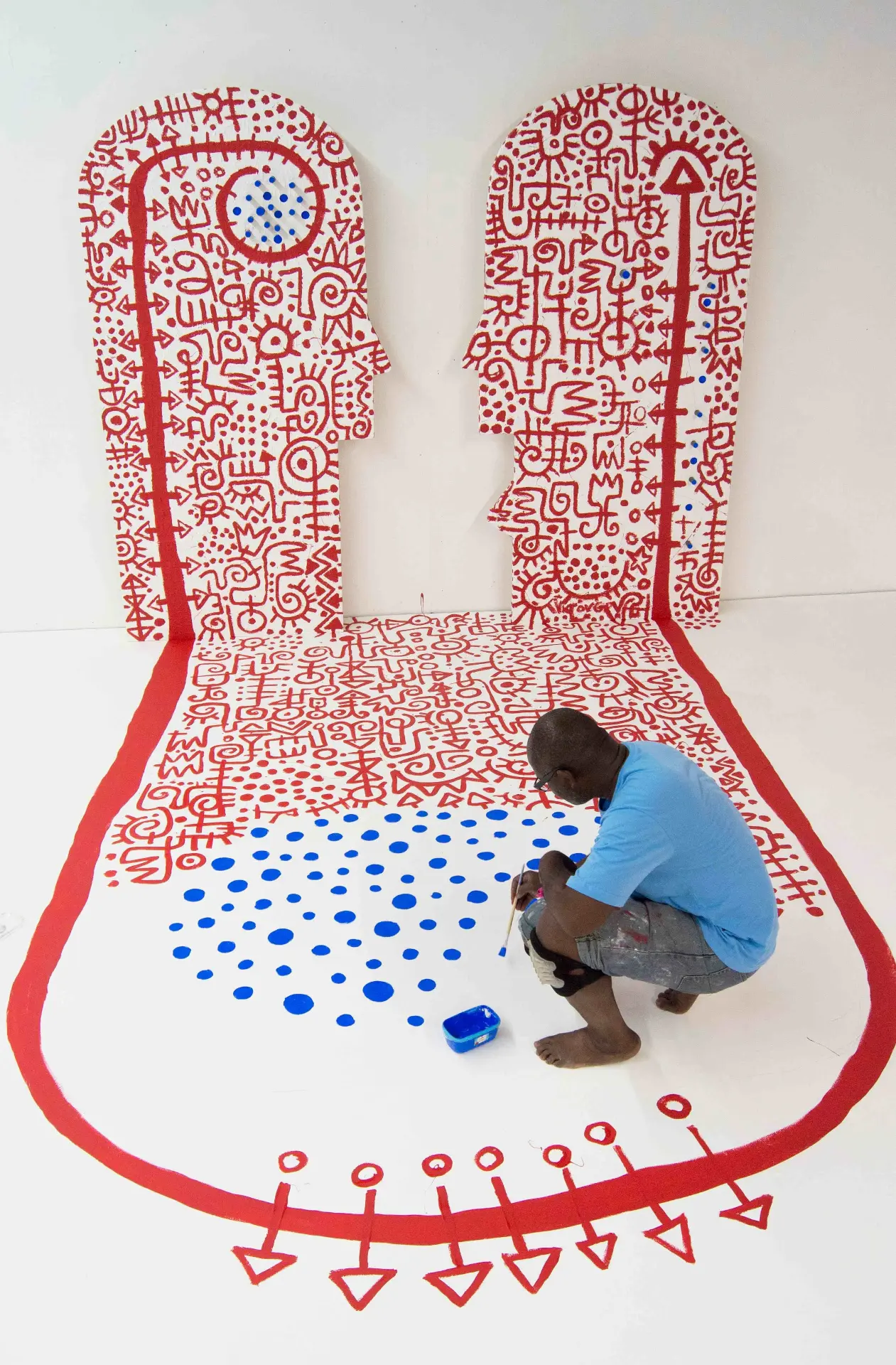 State of Beings (2013). Installation, 86 in. × 200 in. (floor), 178 in. × 41.58 in. (wall). Acrylic, vinyl and metal on wood panel and vinyl mat. Created in Apt, France, during a sculpture workshop to mark the tenth anniversary of Fondation Blachère. Image Cedit: Mabeye Deme and Victor Ekpuk