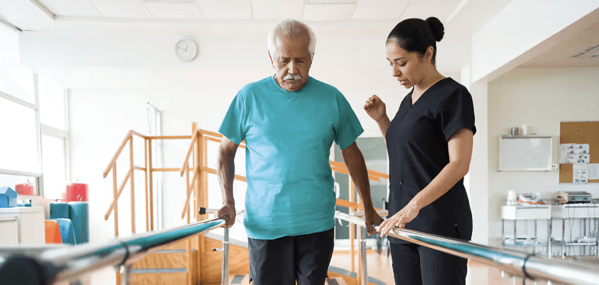 Senior male receiving physical therapy walking after a stroke
