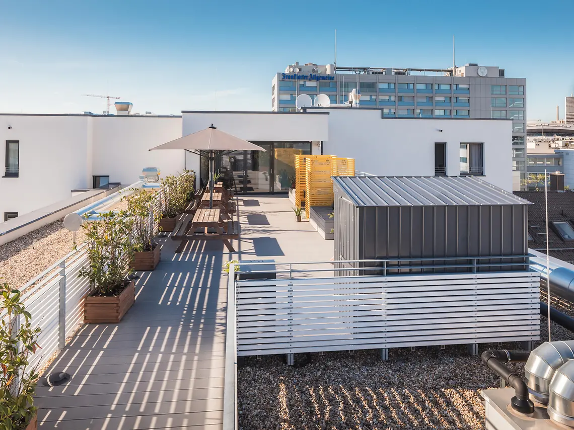 Rooftop terrace at student accommodation in Frankfurt with outdoor seating and city views