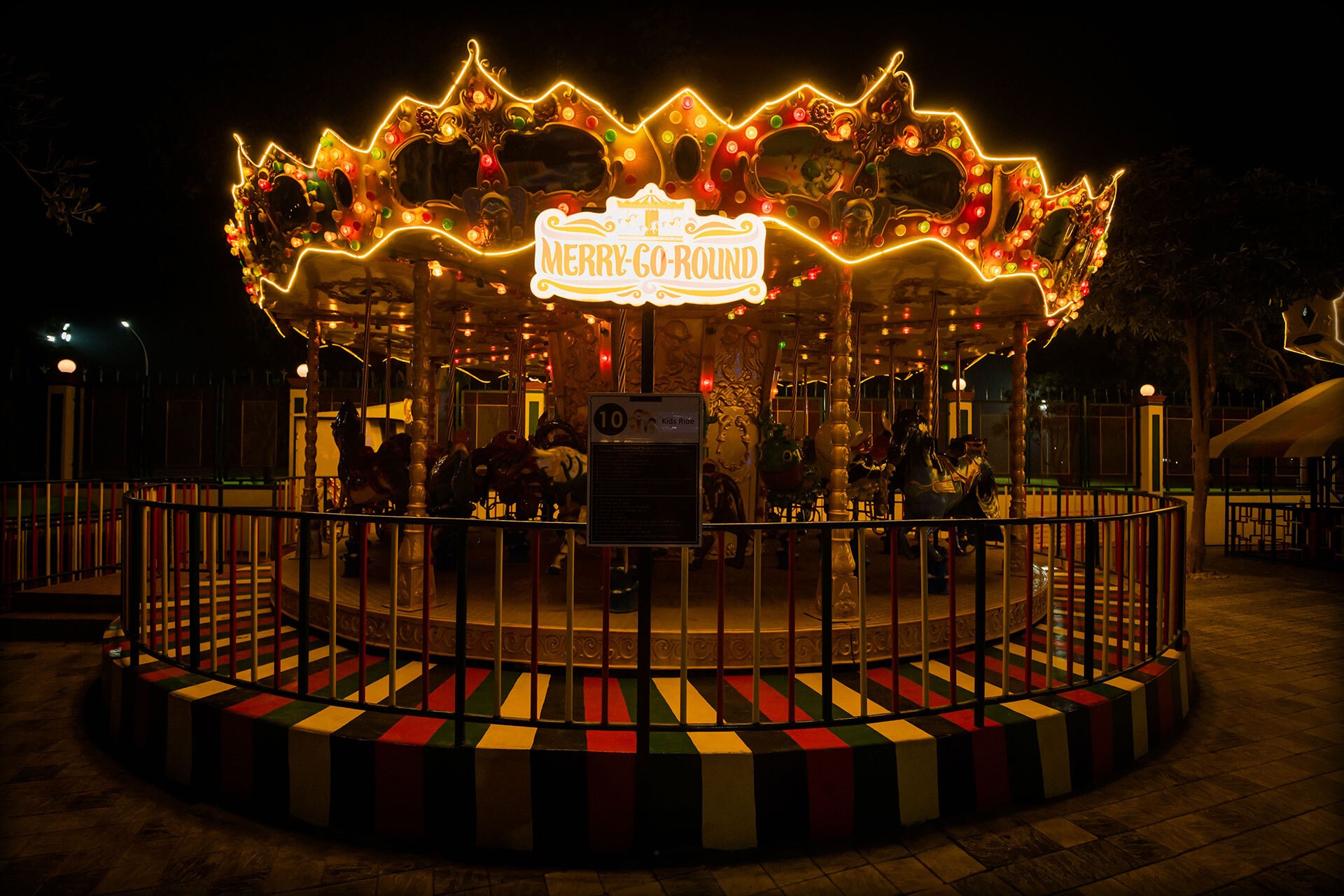 Sunlit orange chair on wooden floor near staircase.