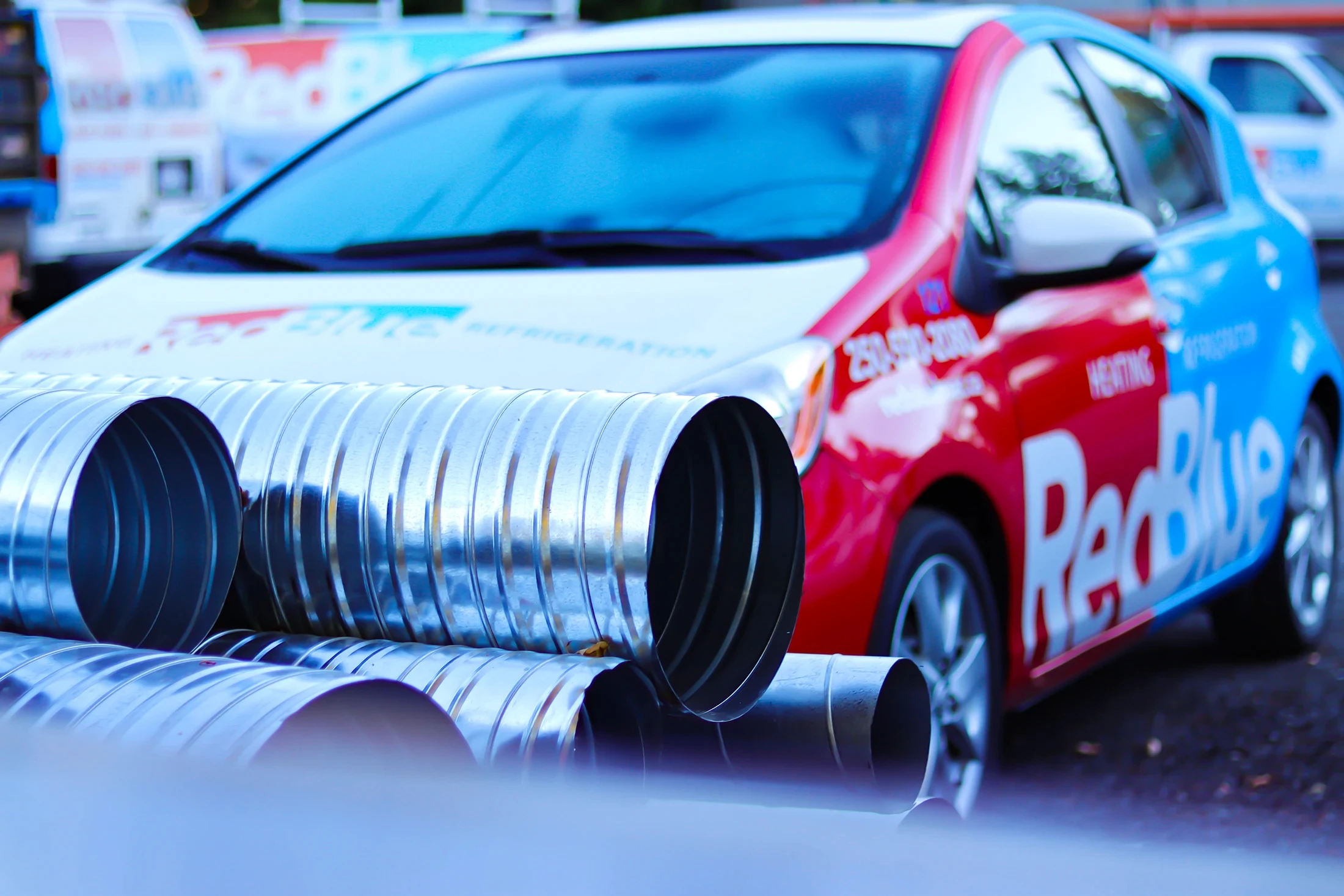 clsoe up of piping and a RedBlue vehicle