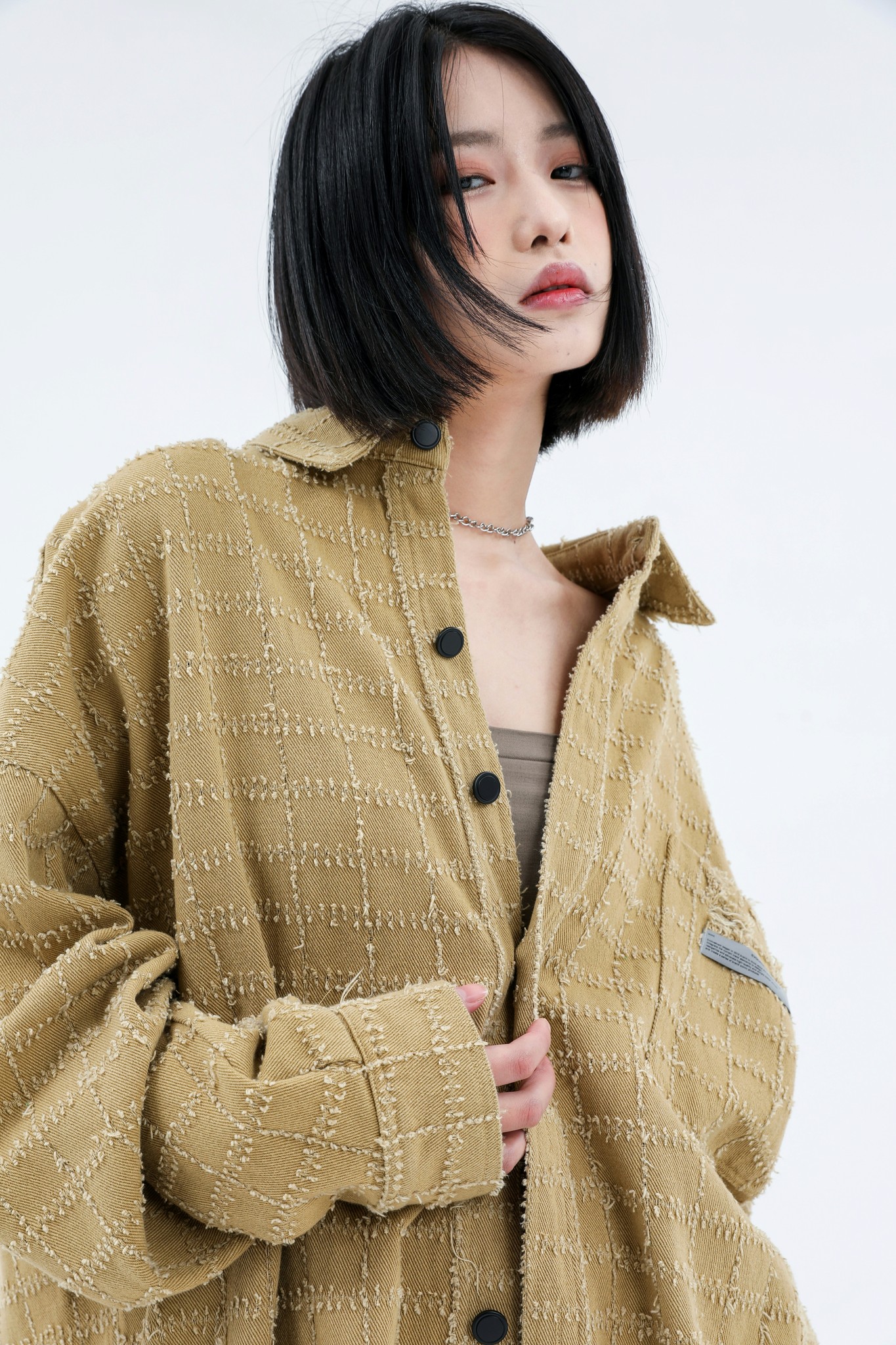 a woman standing with her hands in her pockets