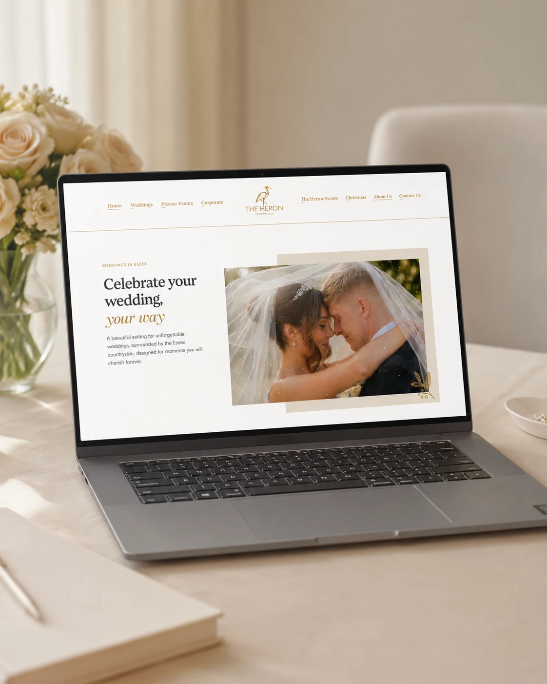 Laptop displaying wedding website with couple.