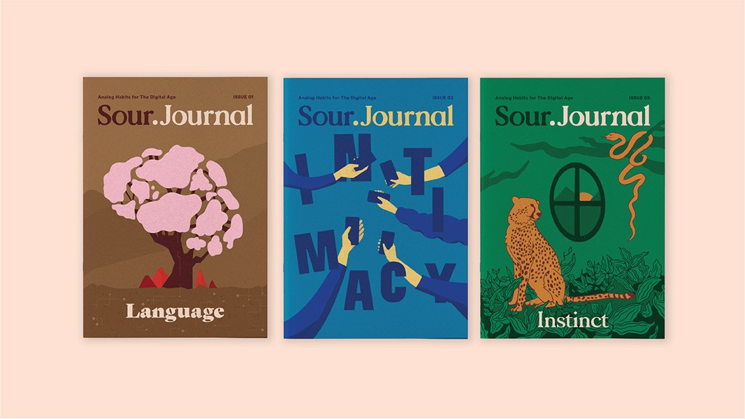 Three magazine covers are displayed side by side. From left to right, the covers are labeled “Language,” “Sour.Journal,” and “Instinct.” The “Language” cover features a pink tree on a brown background. “Sour.Journal” has a blue background with hands reaching across it. “Instinct” has a green background with a cheetah and snake.