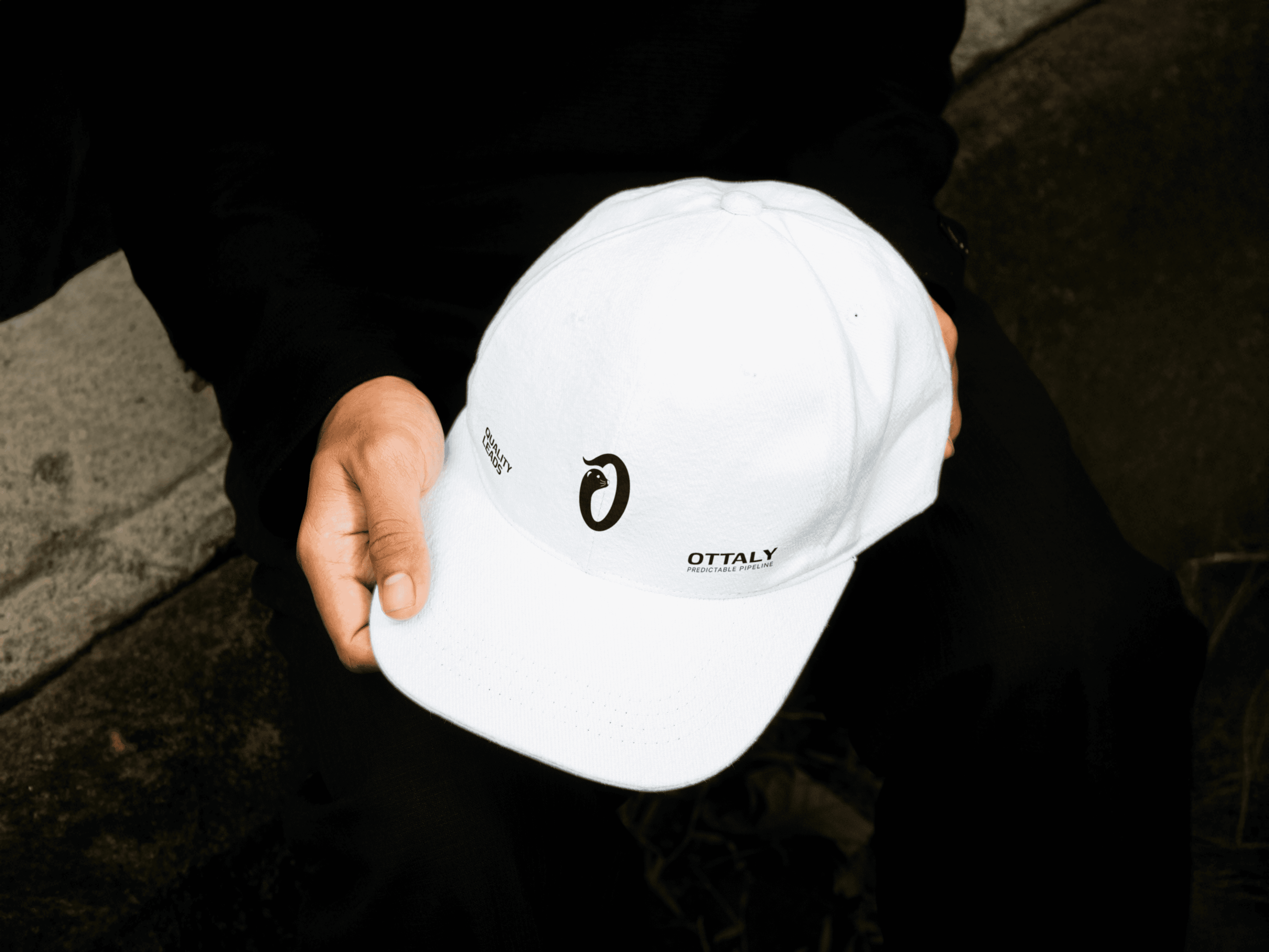 A high-end laptop mockup featuring a digital "Brand Guidelines" presentation for BrandFrame on the screen. The open MacBook is surrounded by an organized grid of closed, metallic space-gray laptops resting on a teal surface. The screen displays a minimalist black UI with white bold typography, a navigation menu, and "Visual Identity 2026" branding.