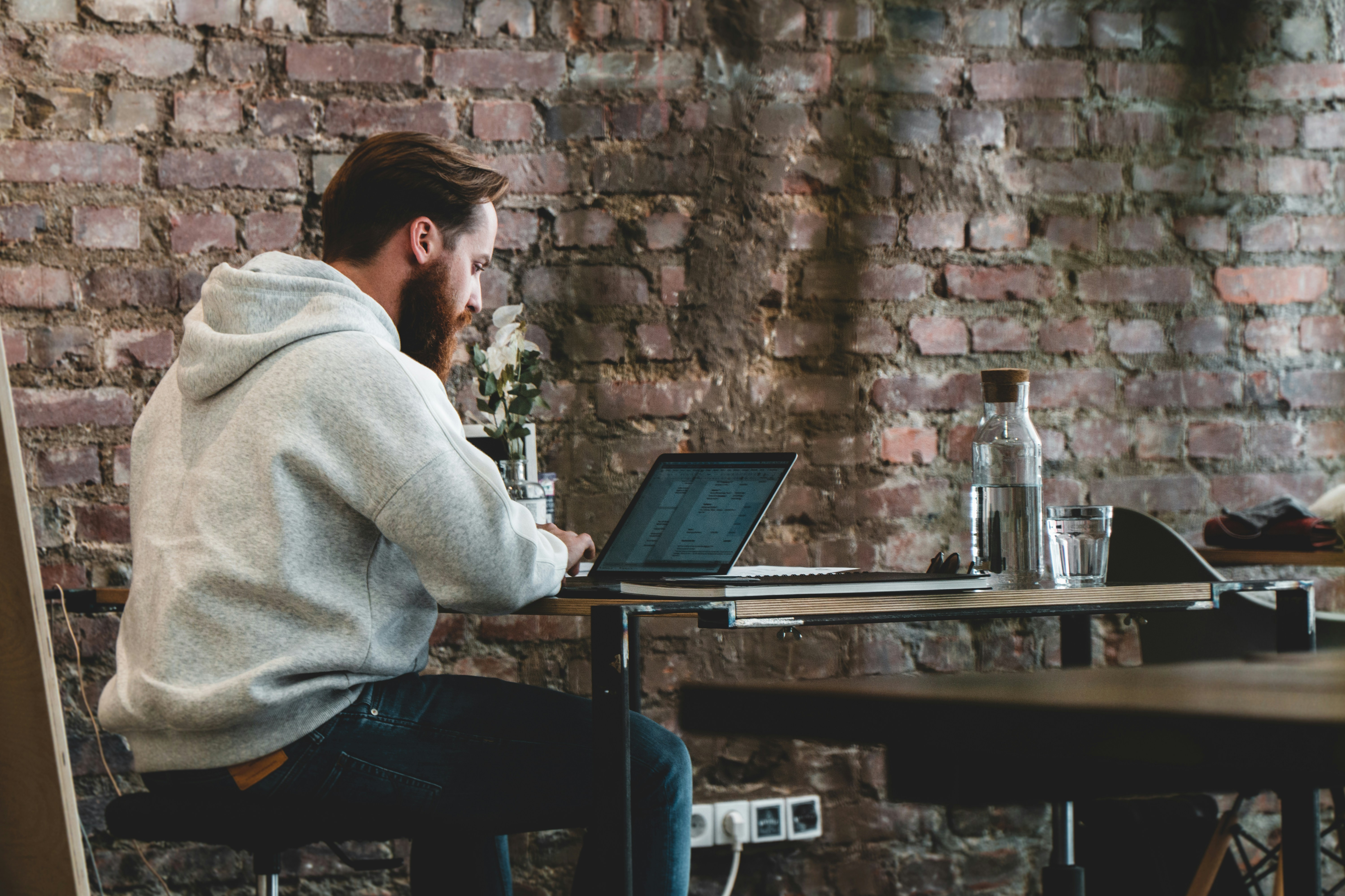 man working alone in his office - AI Organization Tools