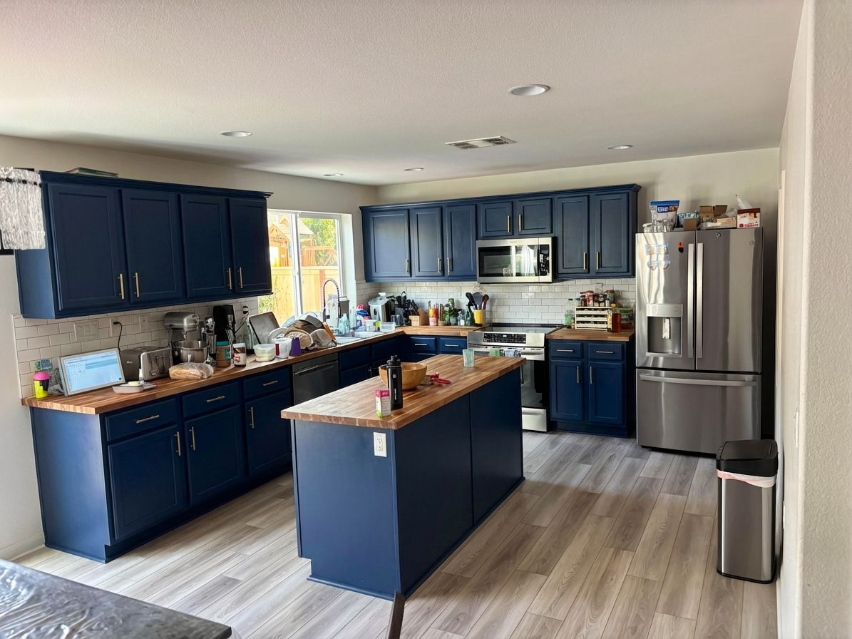 Kitchen with navy blue cabinets and brass hardware designed by AI