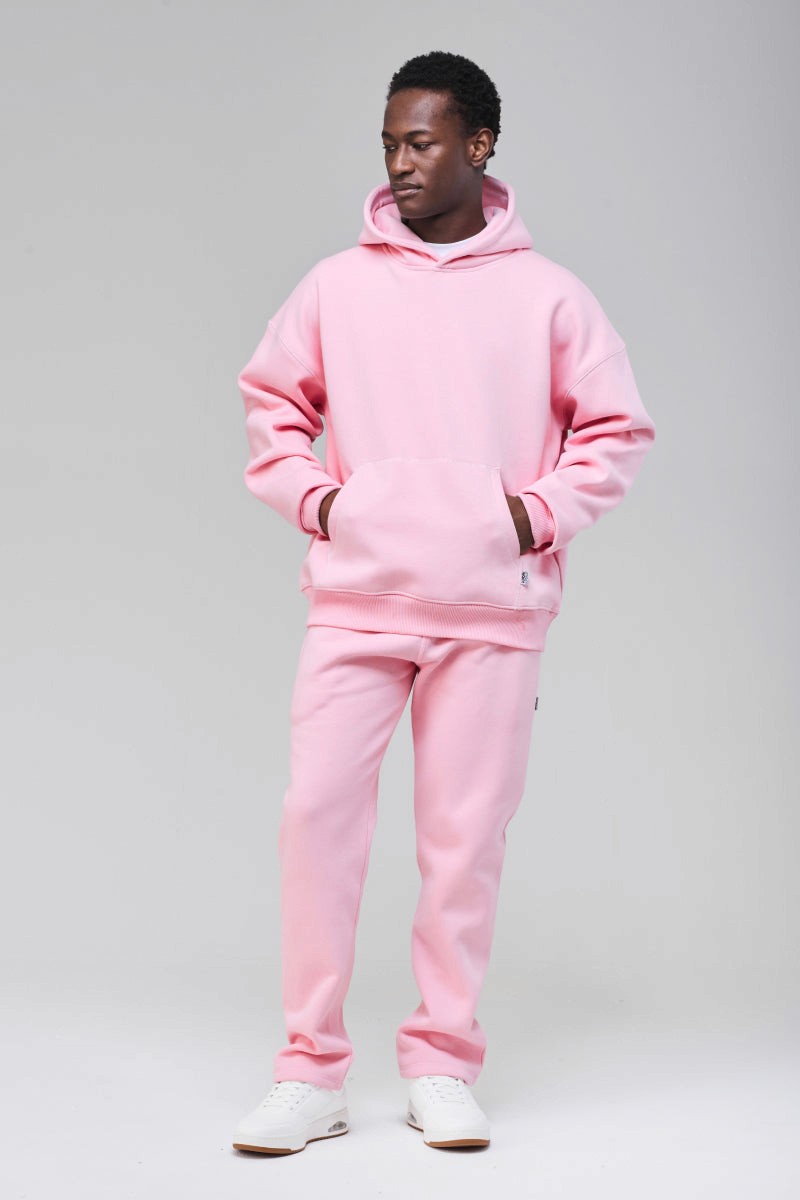 Male model wearing pink heavyweight boxy hoodie, full figure