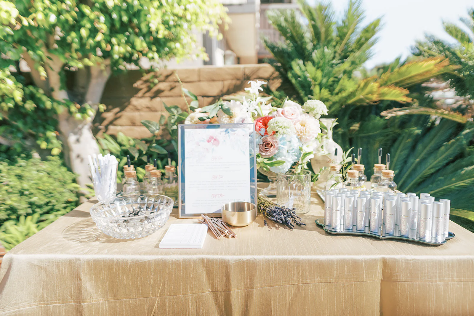 DIY wedding perfume bar with essential oils and glass roller bottles on gold tray