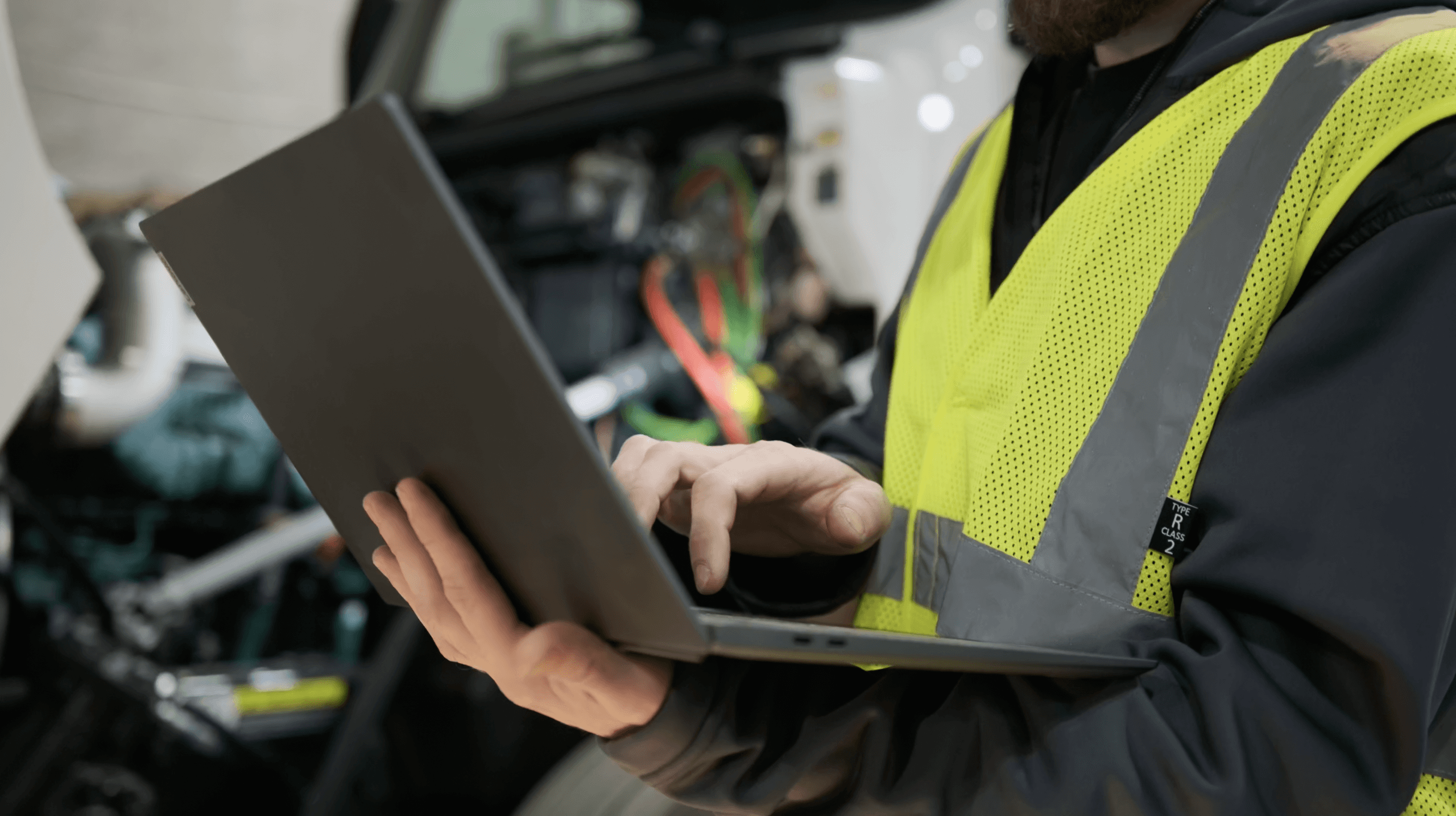 Mechanic analyzing the car with a laptop