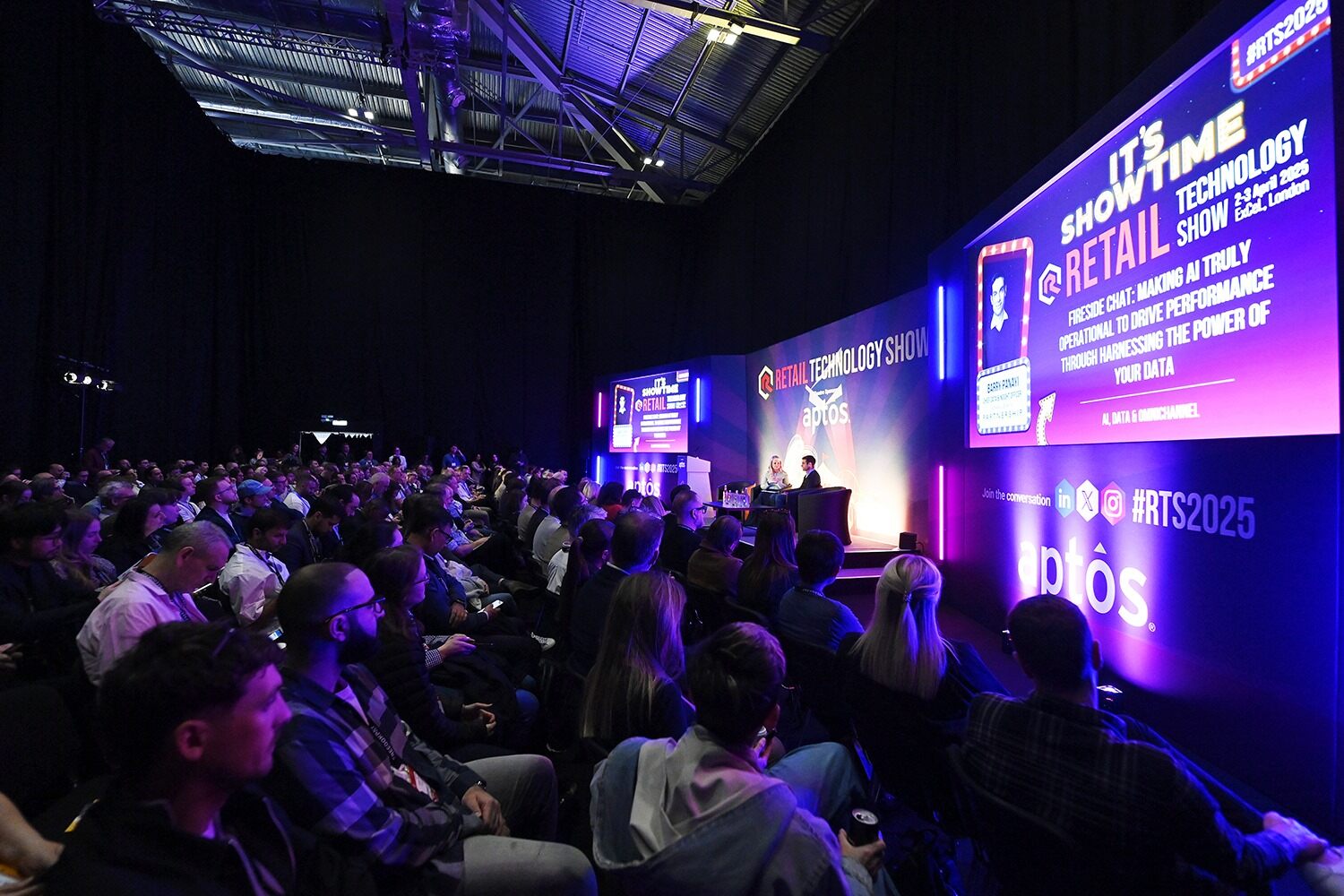 A large truck with a crane parked under clear blue skies and surrounded by palm trees.
