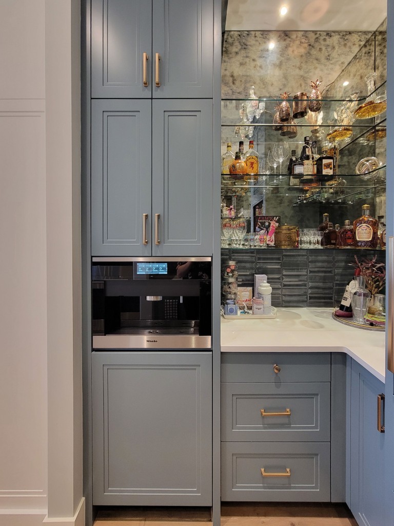 Image of Luxury kitchen interior design with KHD Homes' custom cabinets and wet bar featuring appliances.
