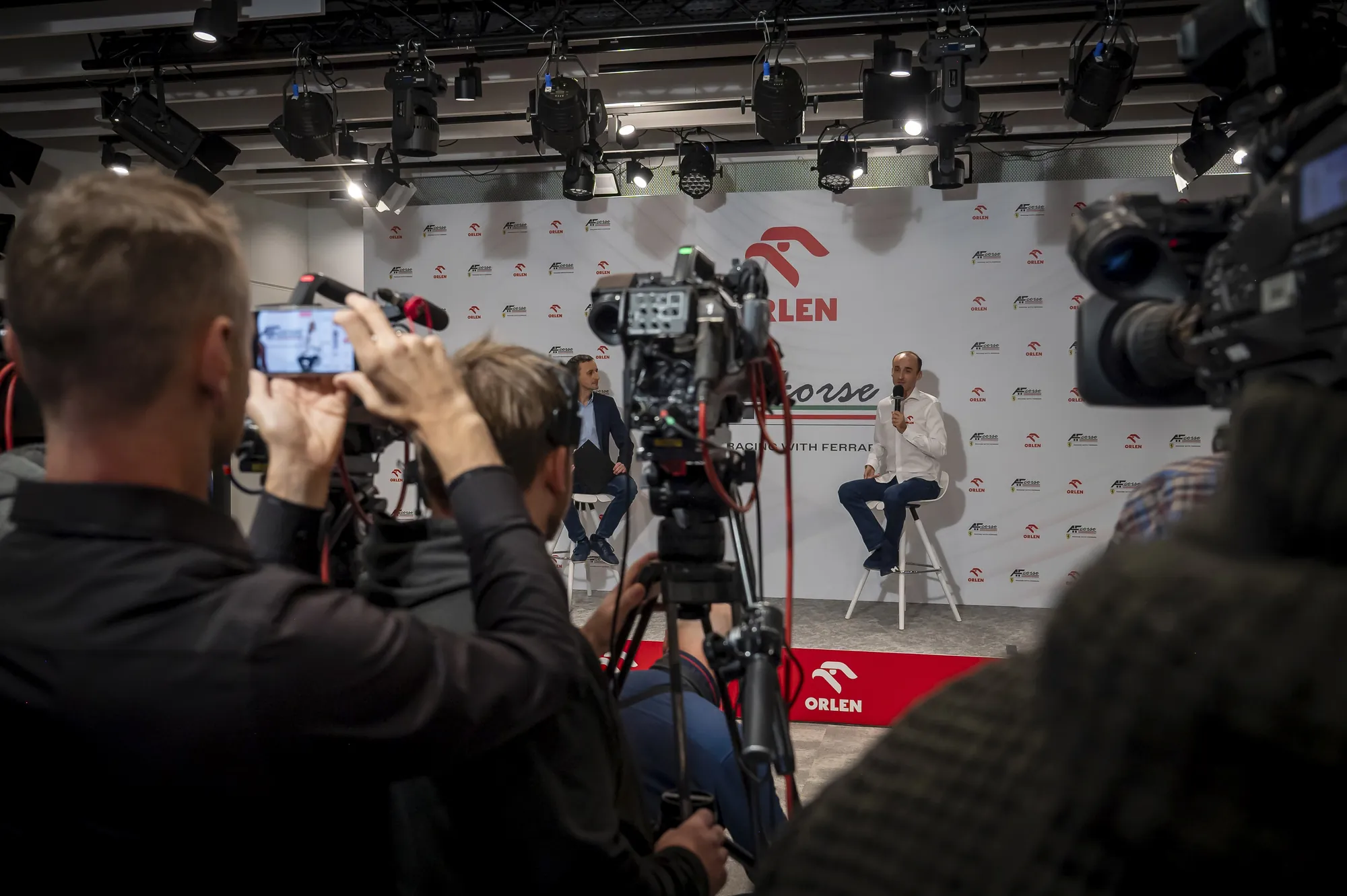 Dziennikarze i operatorzy nagrywają konferencję prasową ORLEN z Robertem Kubicą.