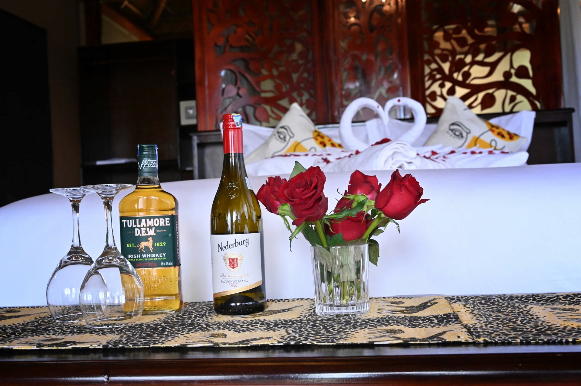 Villa bed with flowers and welcome drinks