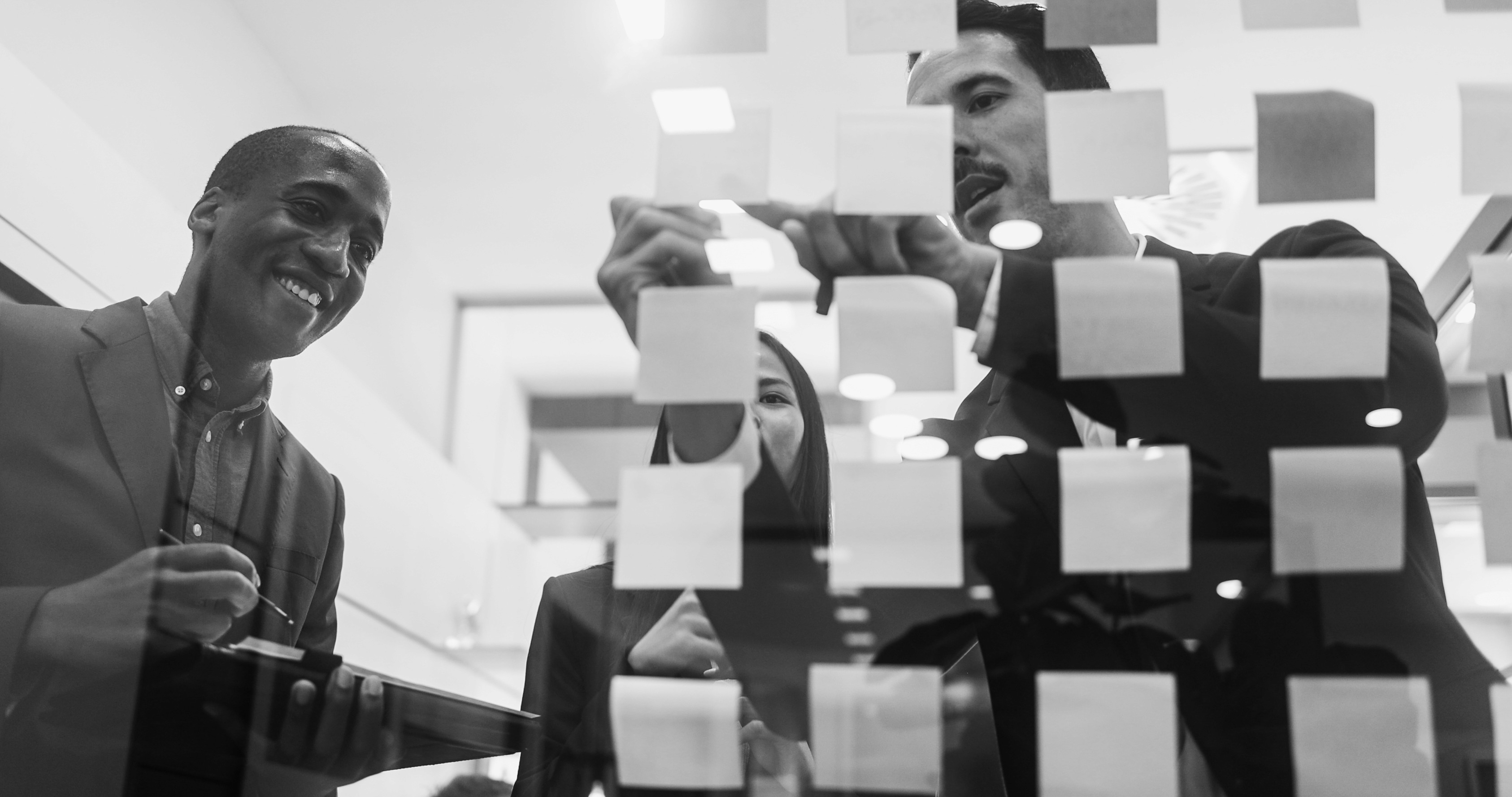 a bulletin board covered in sticky notes in an office