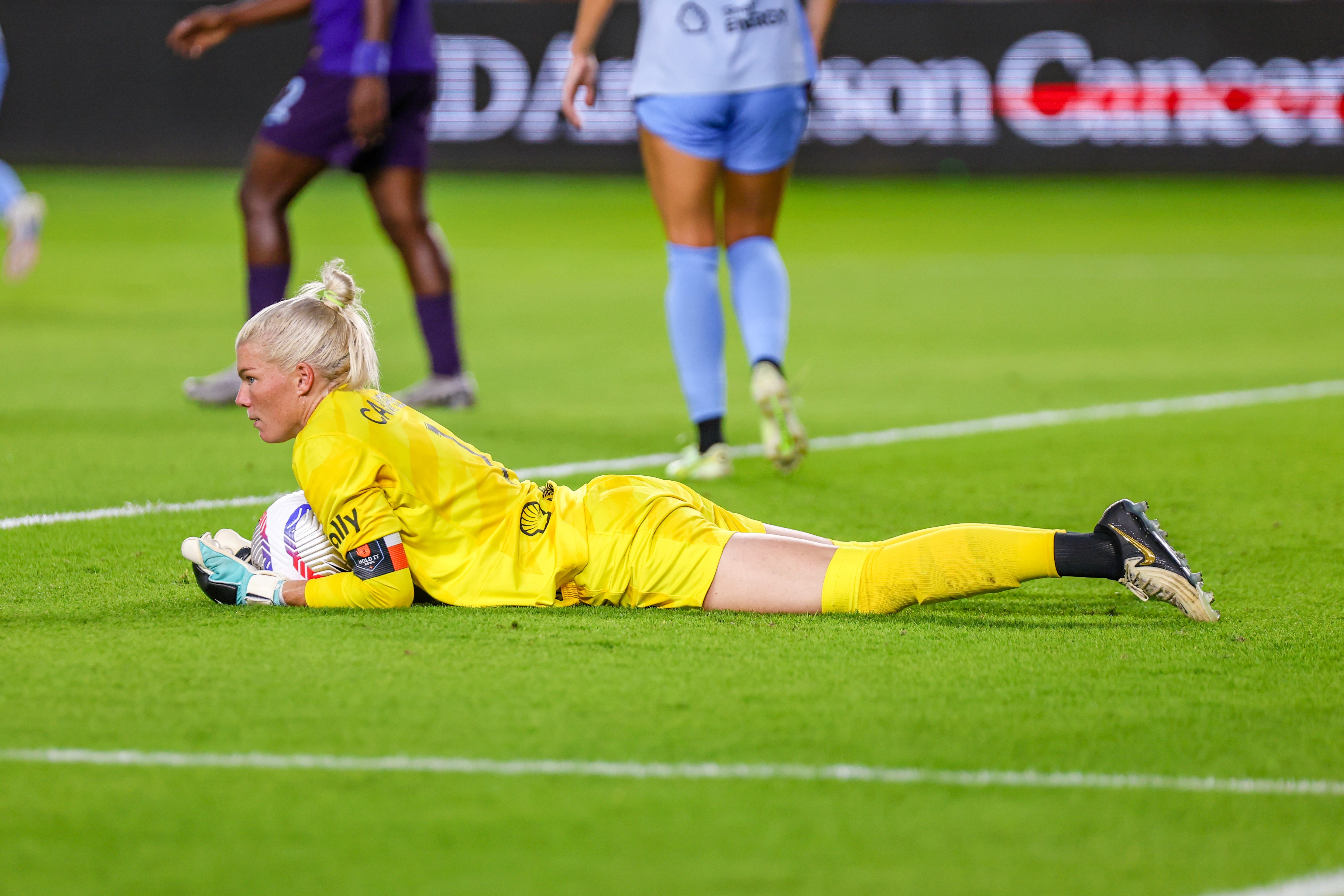 Jane Campbell (1) of the Houston Dash holds on to the ball after saving a shot taken by Barbra Banda (22) of the Orlando Pride during an NWSL game between the Houston Dash and the Orlando Pride at Shell Energy Stadium on August 23, 2024 in Houston. (Photo by Parker George/Undrafted)