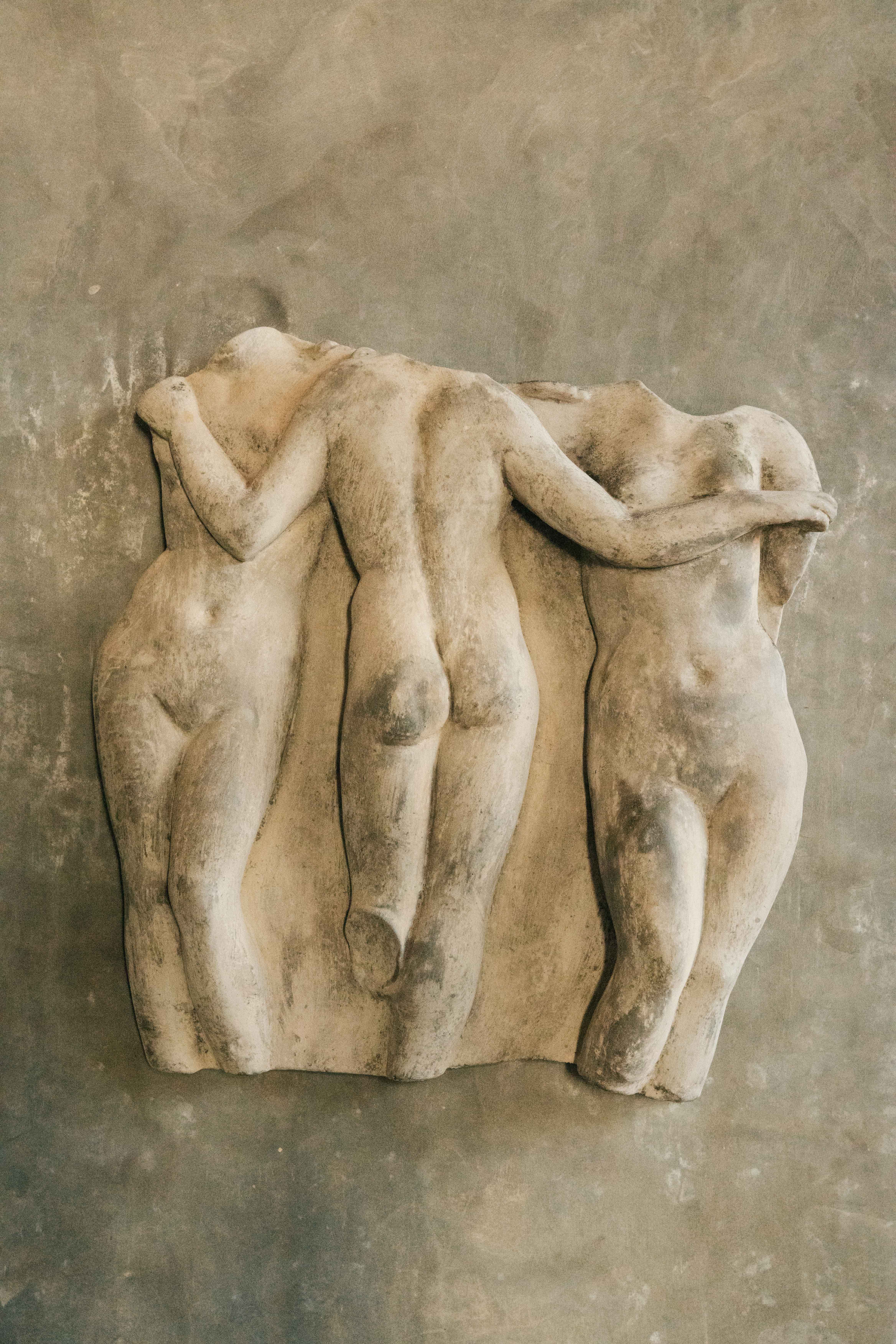 wall sculpture of three women bodies