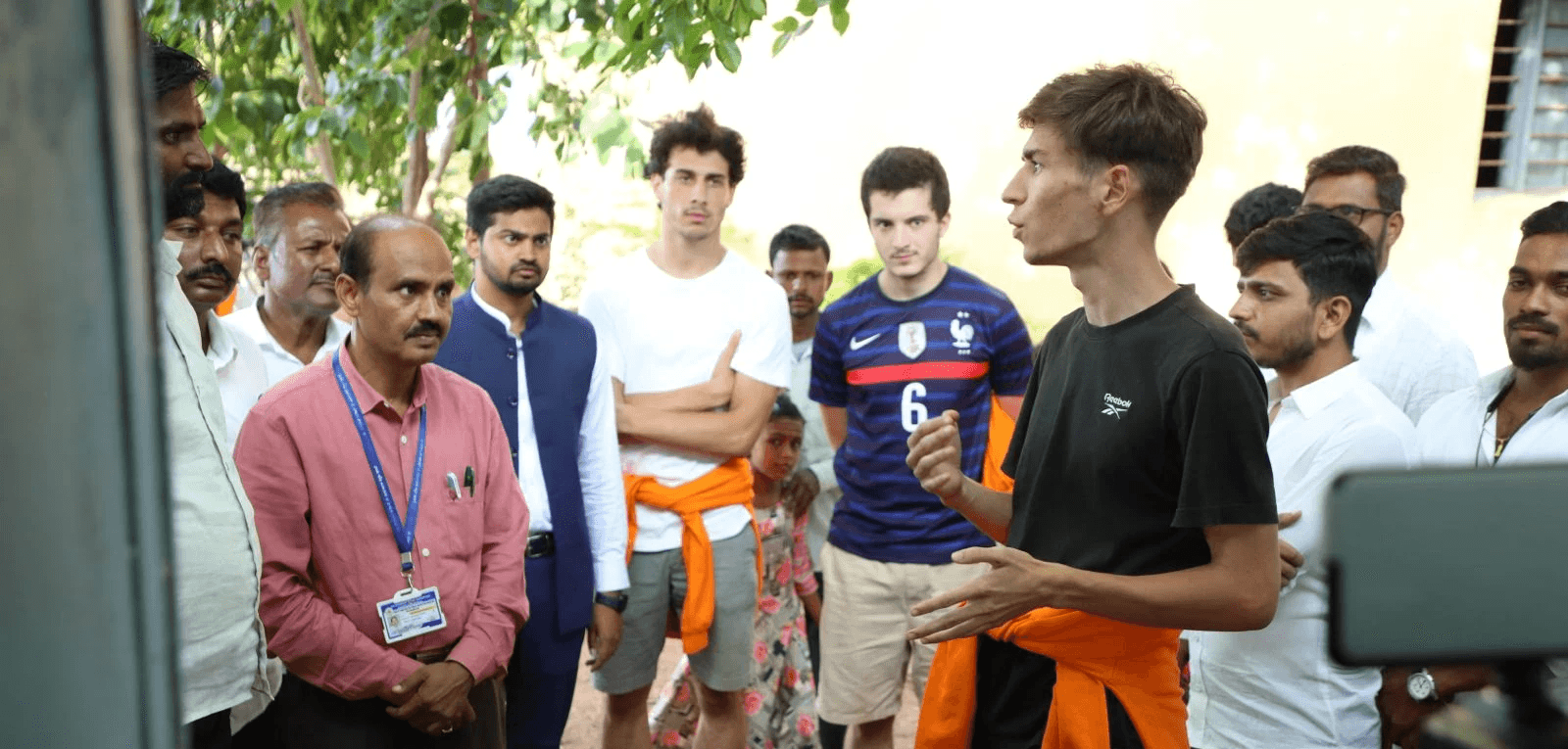 Three children jumping in burlap sacks during a race.