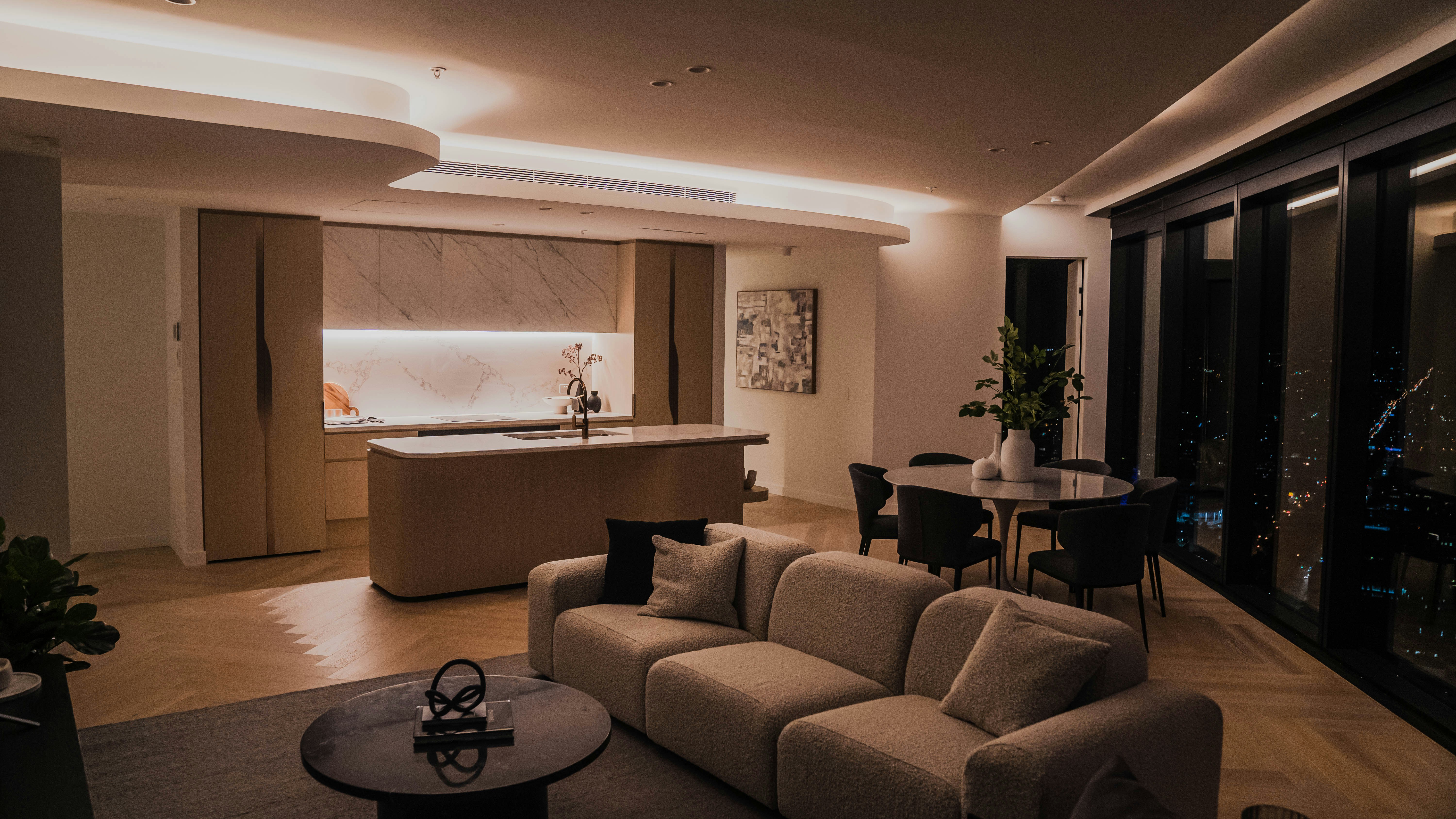 a living room filled with furniture and a kitchen