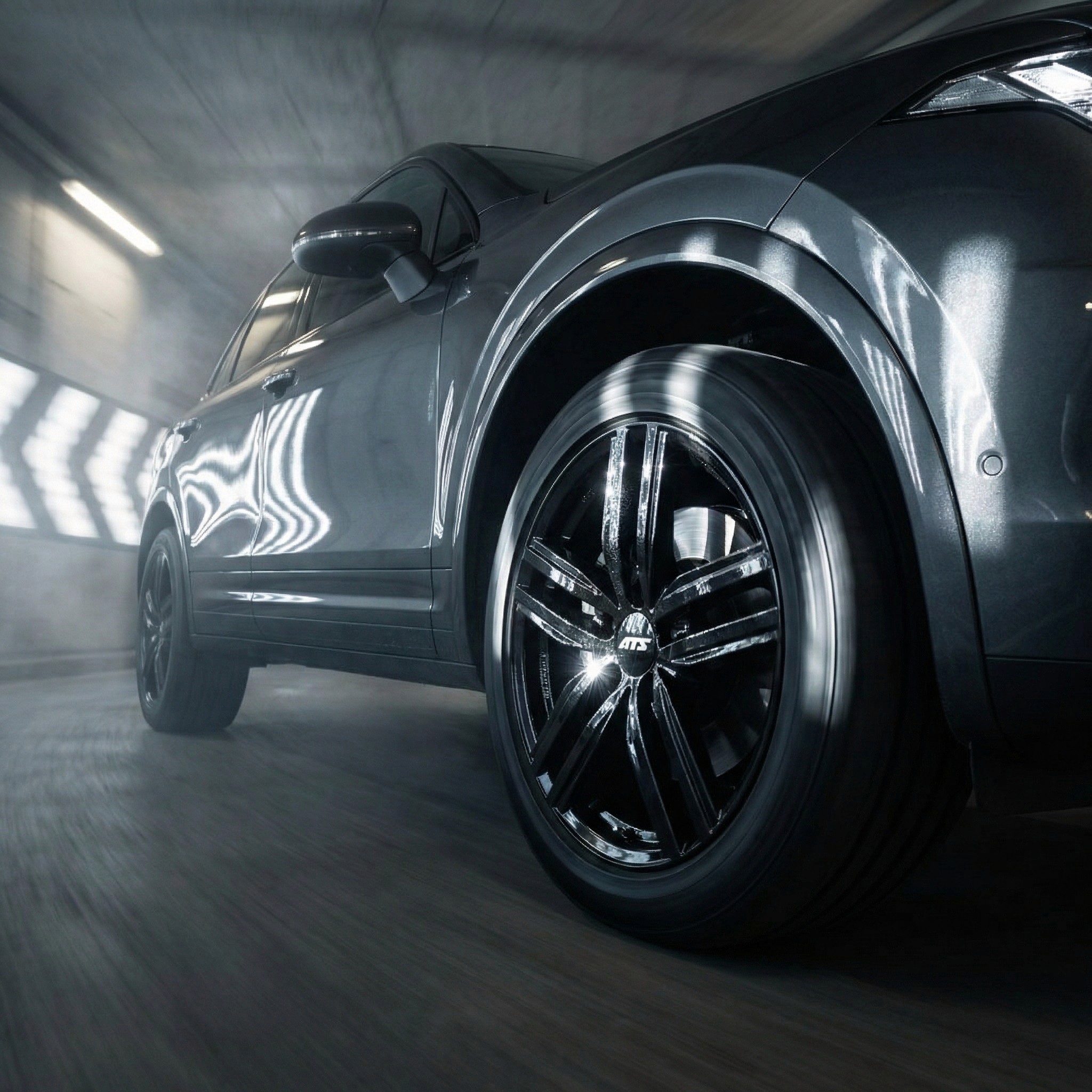 Smiling young man with short hair poses against a dark background, wearing a green button-up shirt.