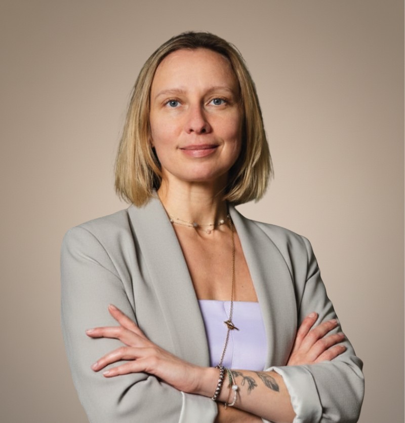 woman in brown coat using macbook air
