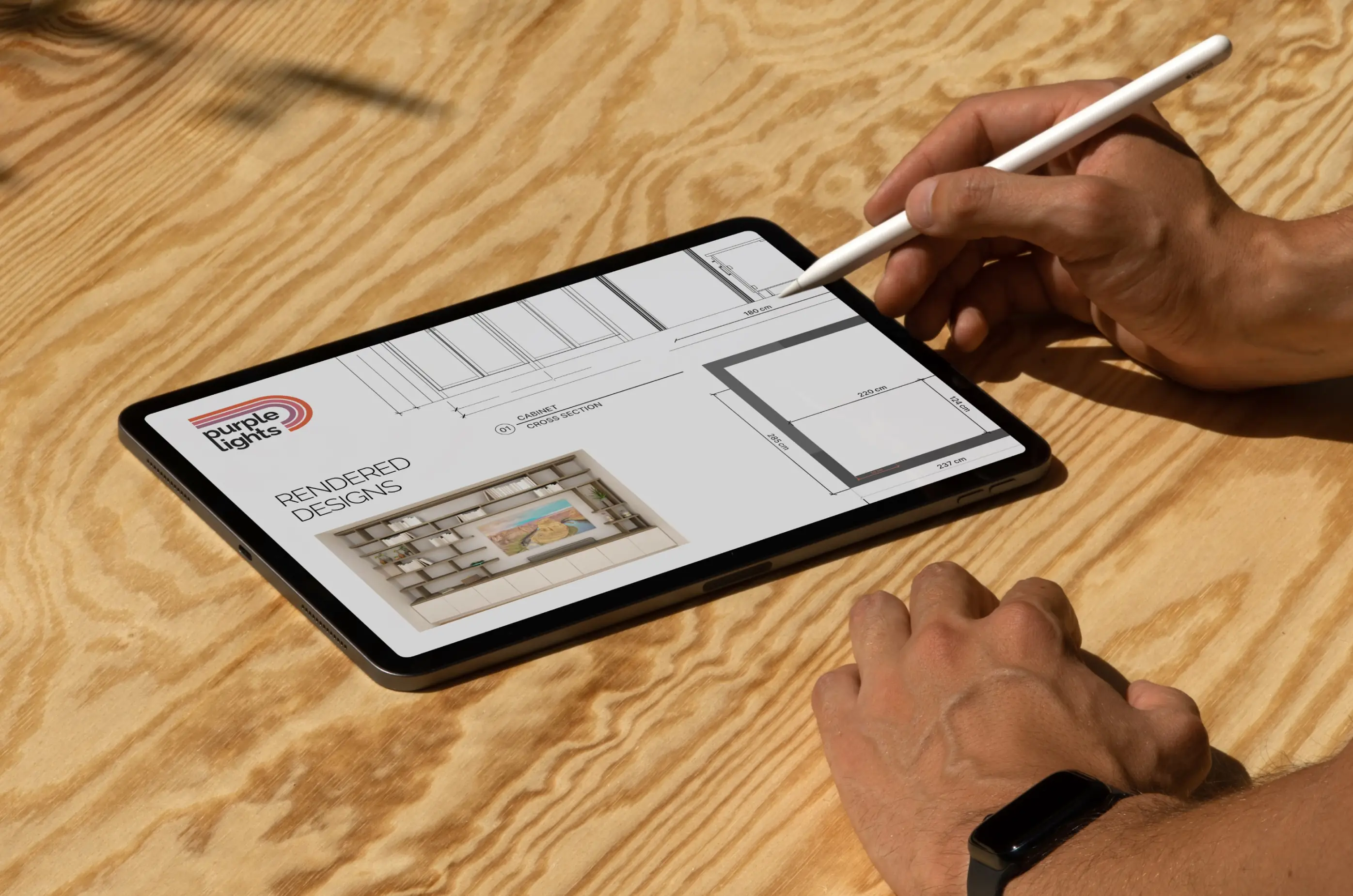 Purple Lights — Designer sketching on iPad with logo and client blueprints — Creative direction