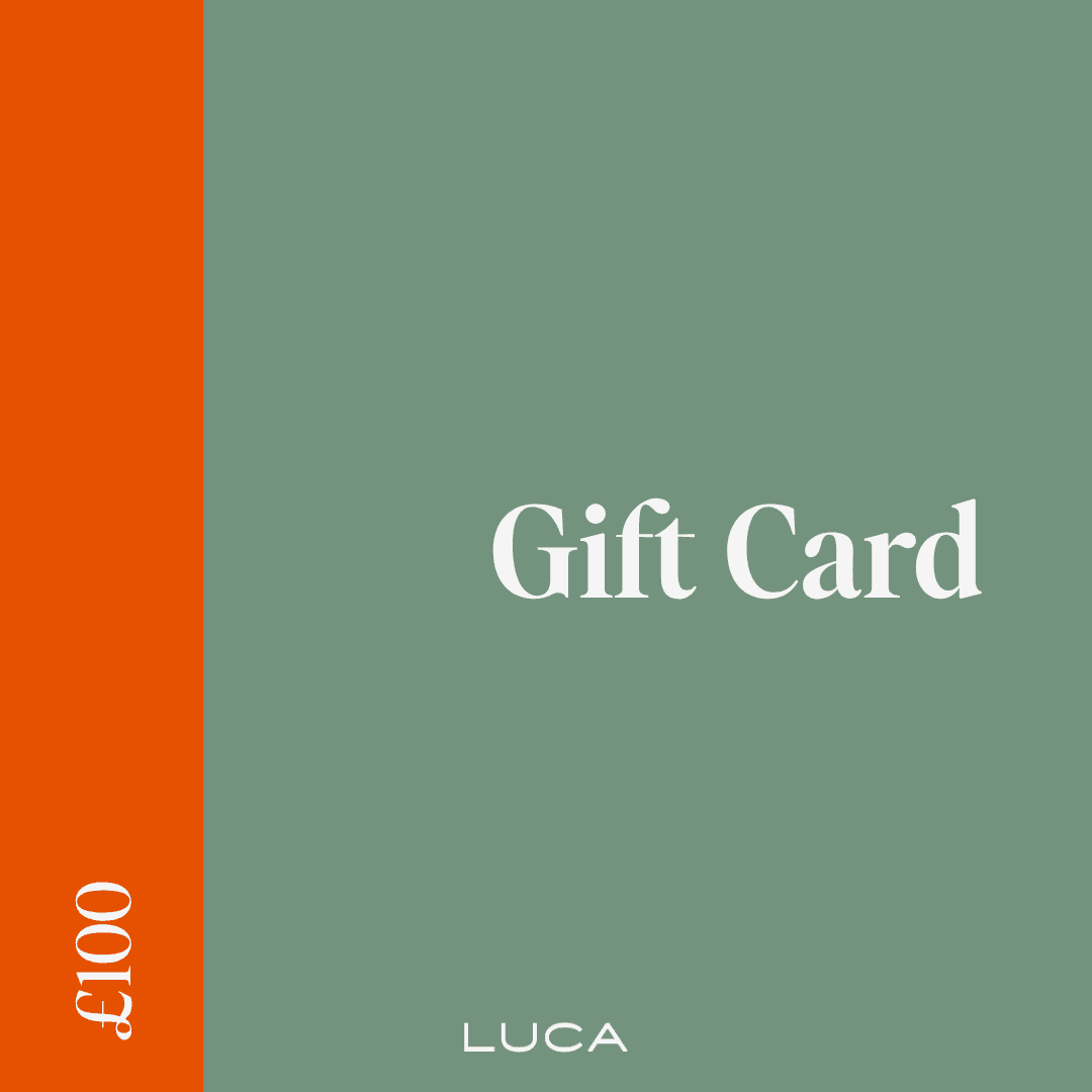 Cyclist wearing LUCA Uplift scrunchie in matcha holding a ponytail, back view