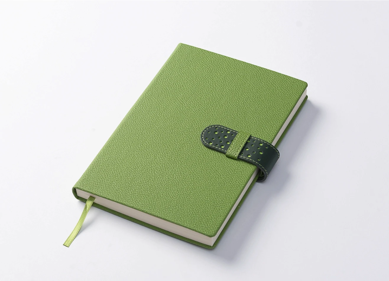 High-angle view of a closed lime green diary resting on a white surface, highlighting the textured cover and secure dark green loop closure.