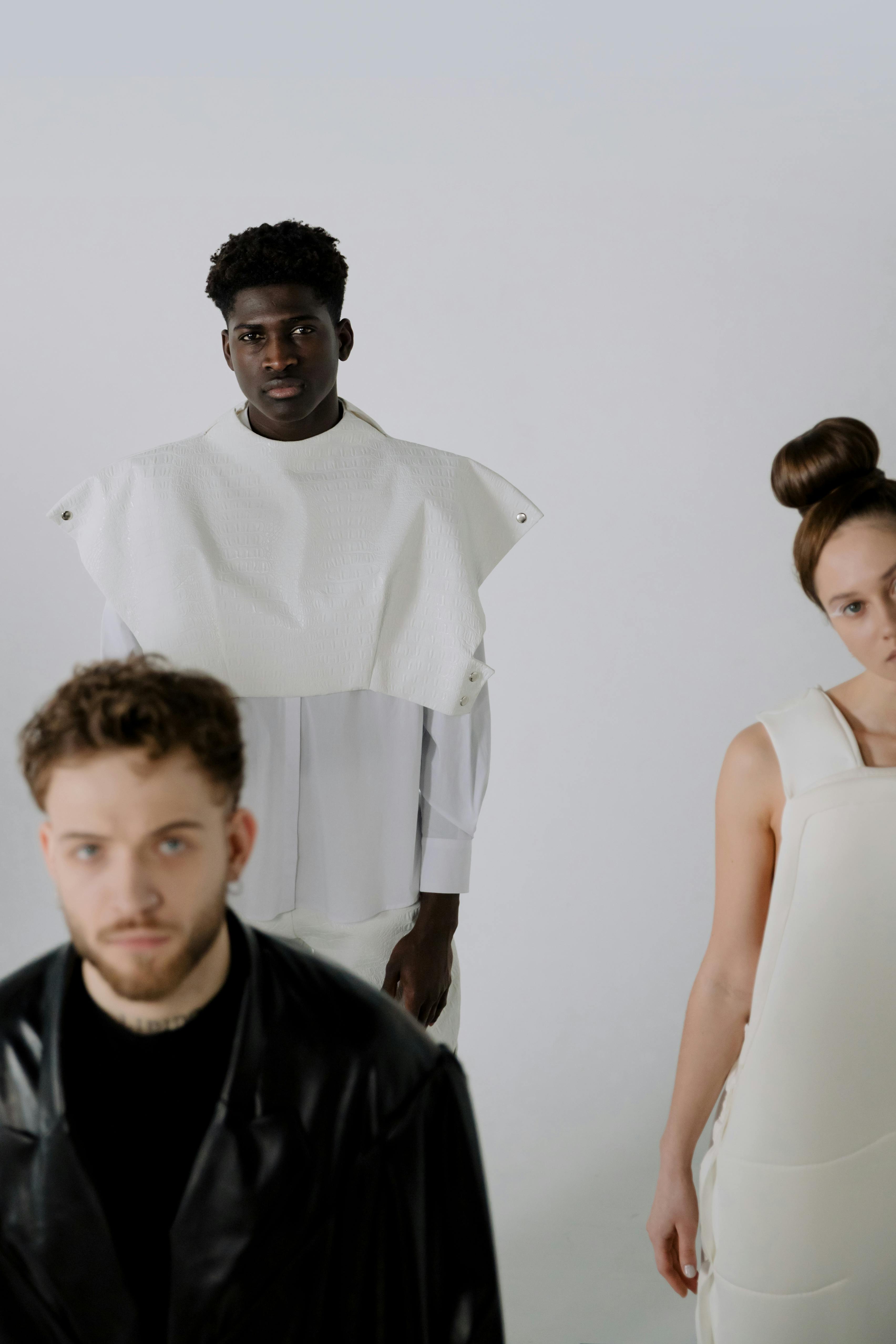Group fashion portrait of three models in white clothing