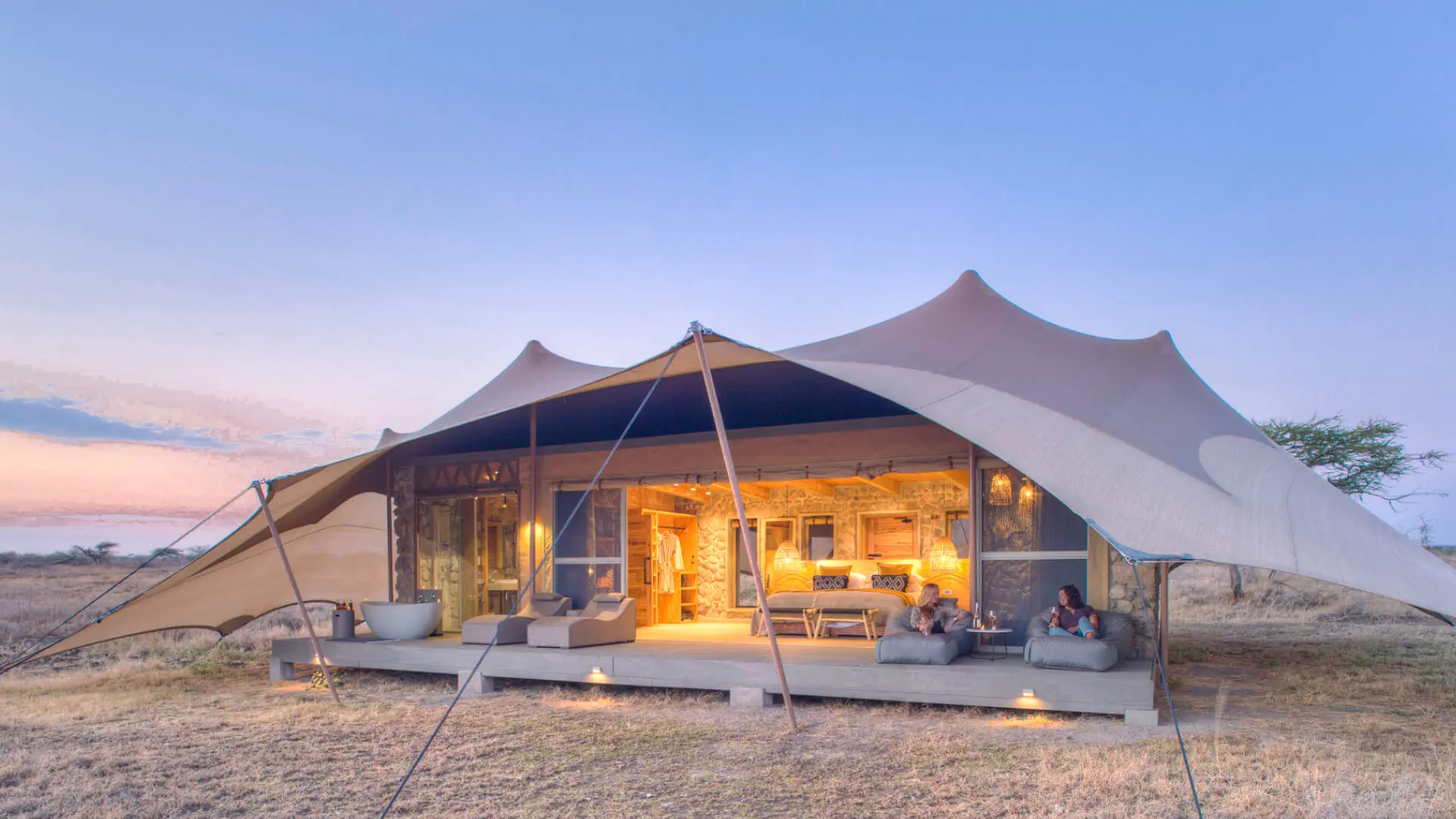 Namiri Plains tented accommodation opening onto the eastern Serengeti landscape at dusk.