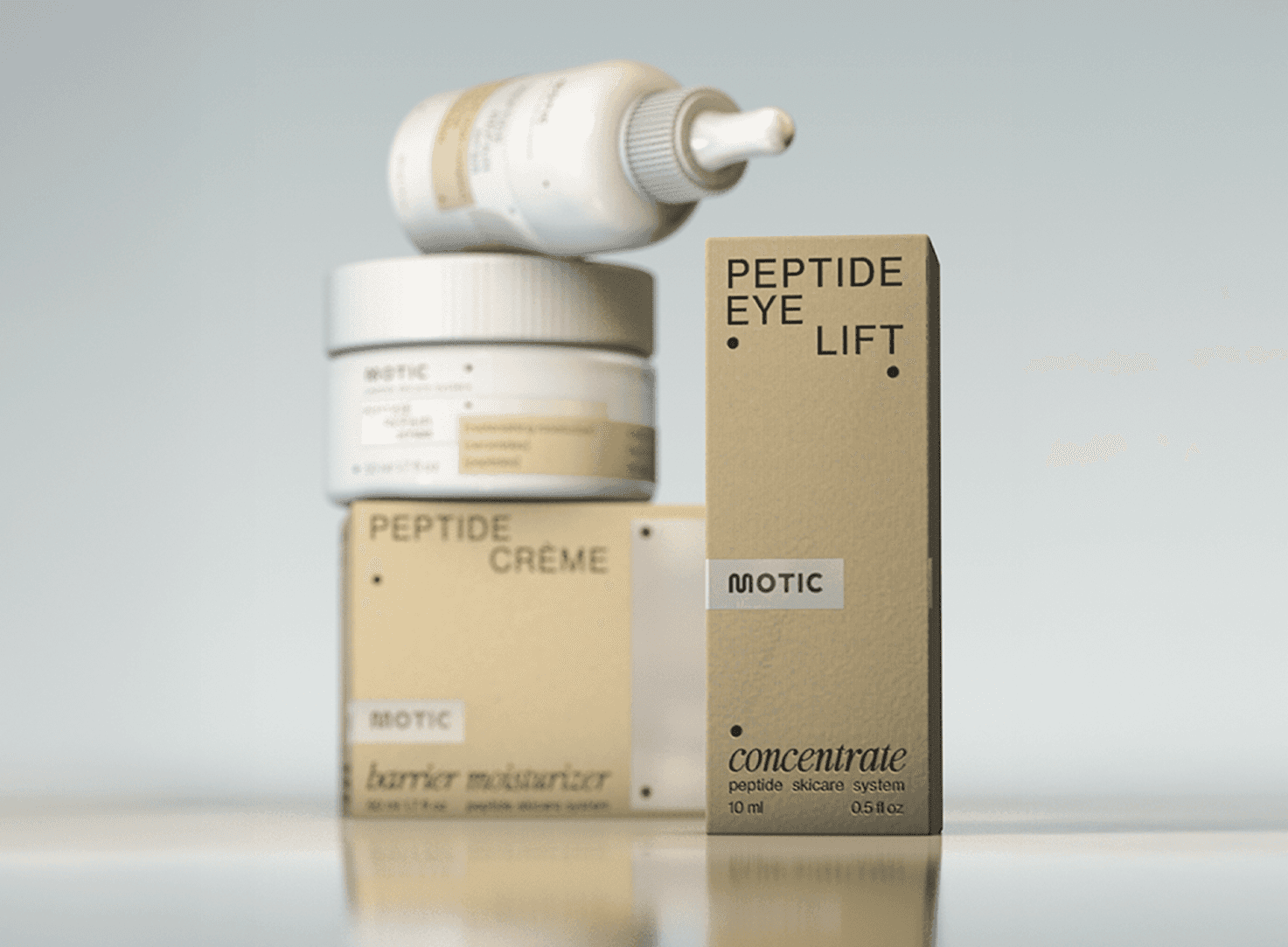 Three people in conversation with warm lighting, including a person wearing a hat and another person wrapped in what appears to be a textured shawl or sweater.