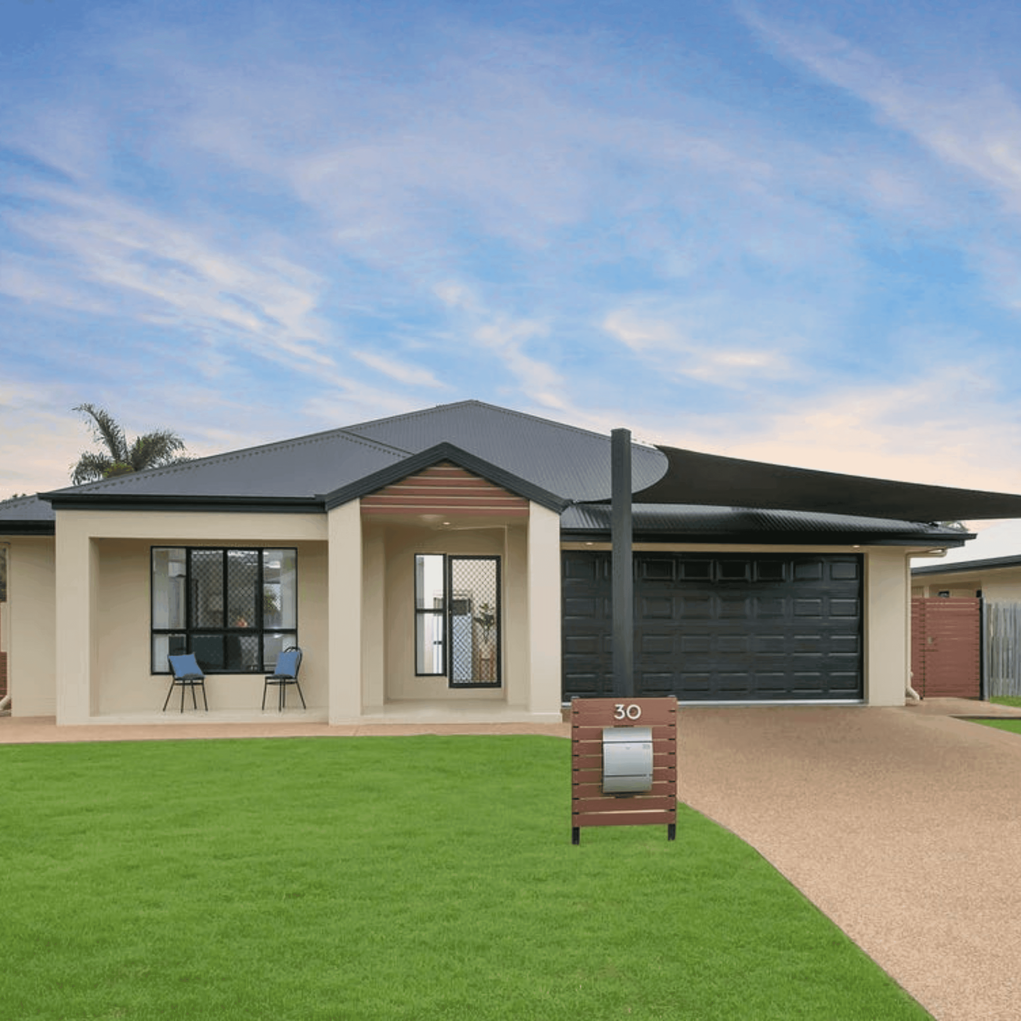 View of modern house with garage and mailbox.