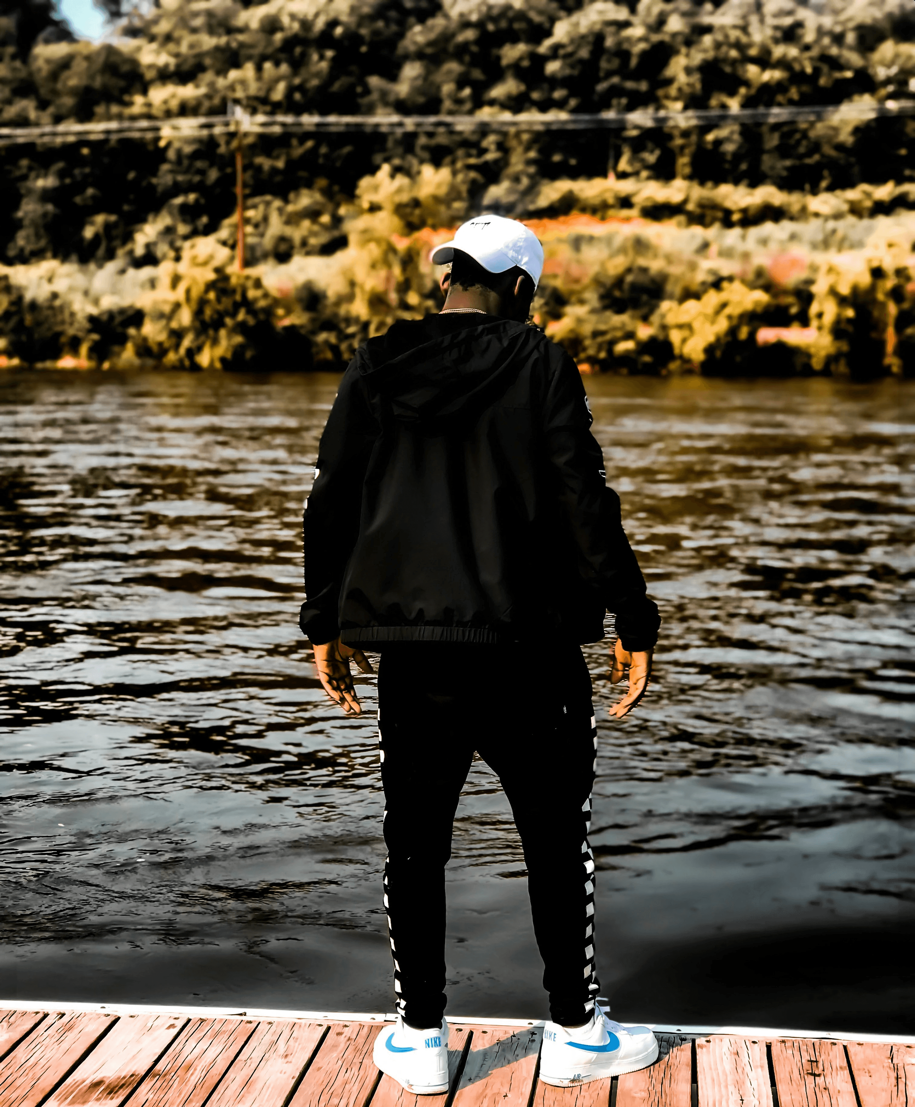 unknown person standing on dock near body of water